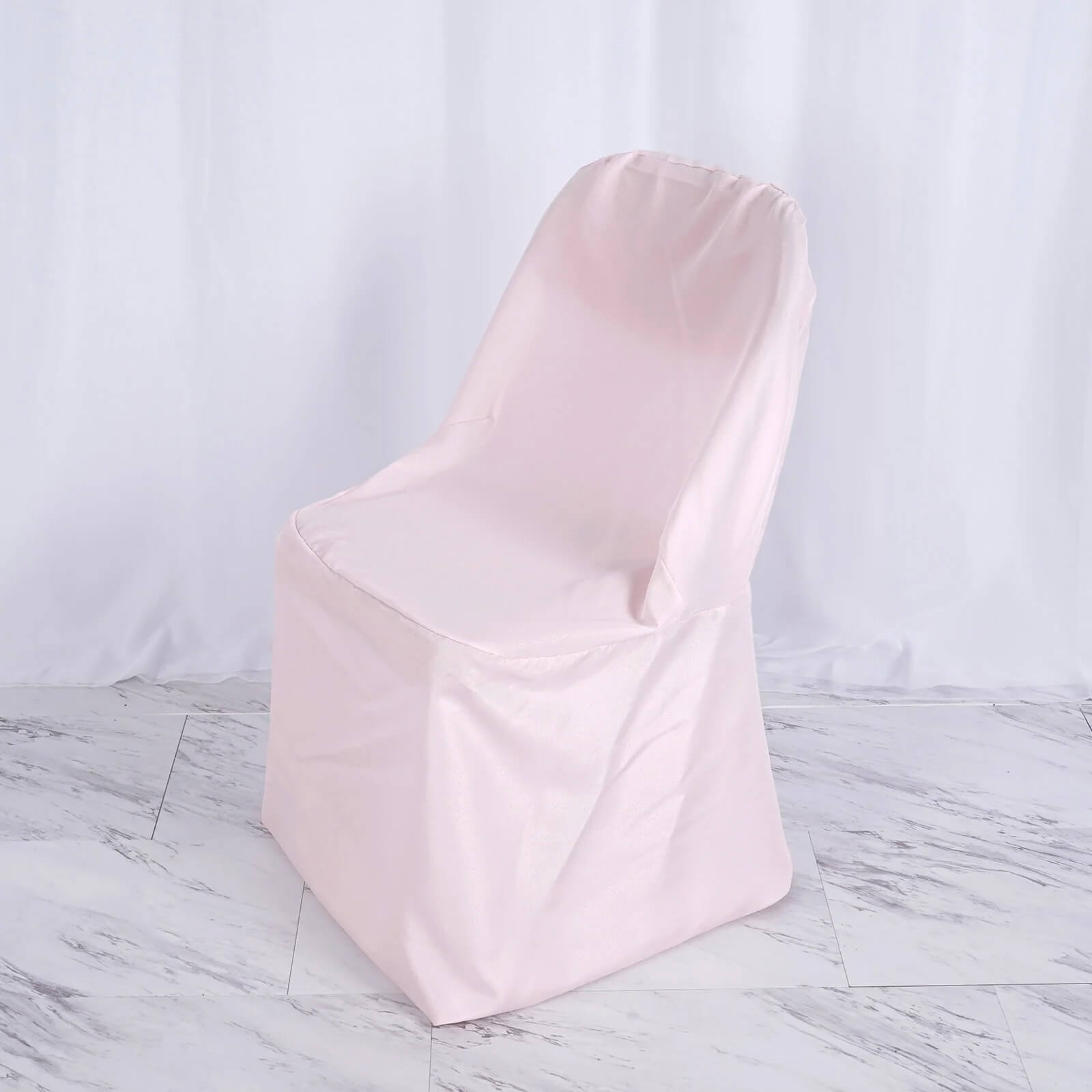 Blush polyester folding chair cover, reusable and stain resistant.