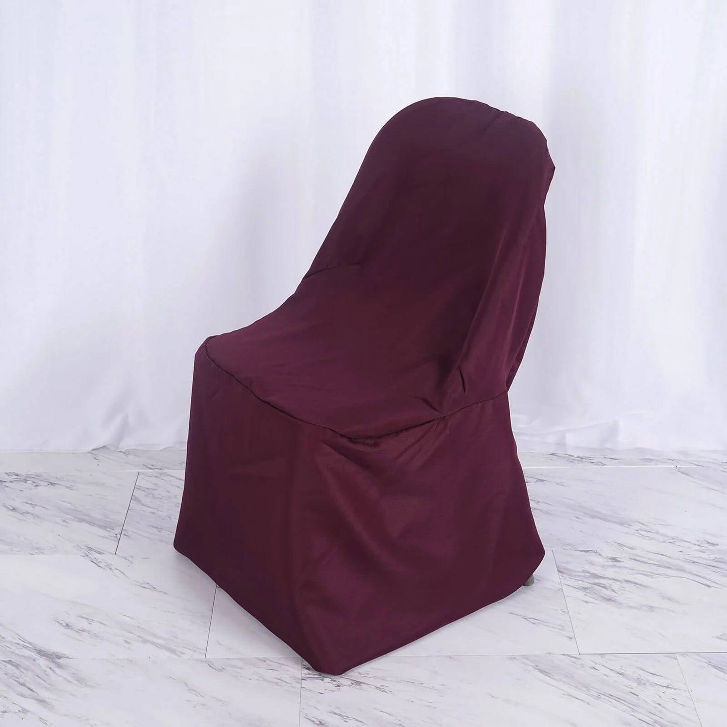Burgundy polyester folding chair cover, reusable and stain resistant.