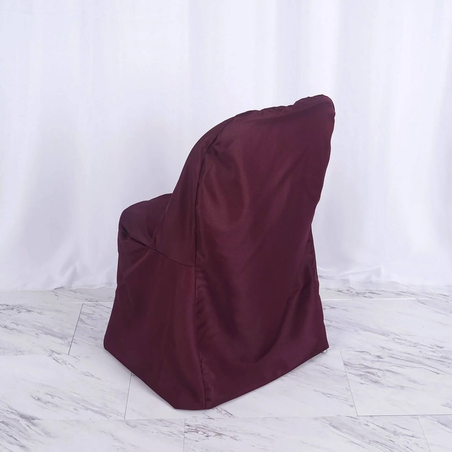 Burgundy polyester folding chair cover, reusable and stain resistant.