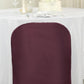 Burgundy folding chair cover on a white table setting.