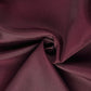Burgundy polyester folding chair cover fabric close-up.