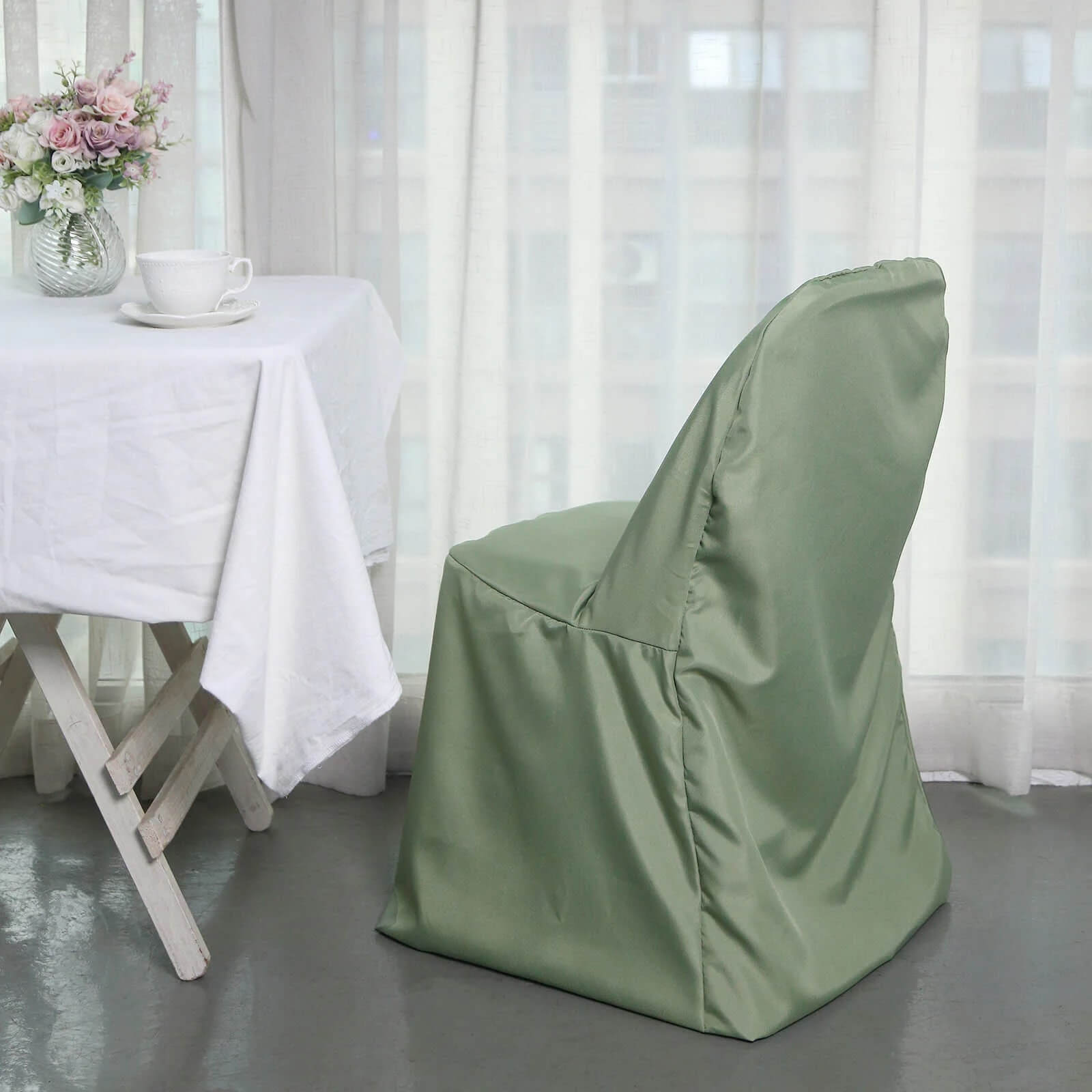 Dusty sage green polyester folding chair cover, reusable and stain resistant.