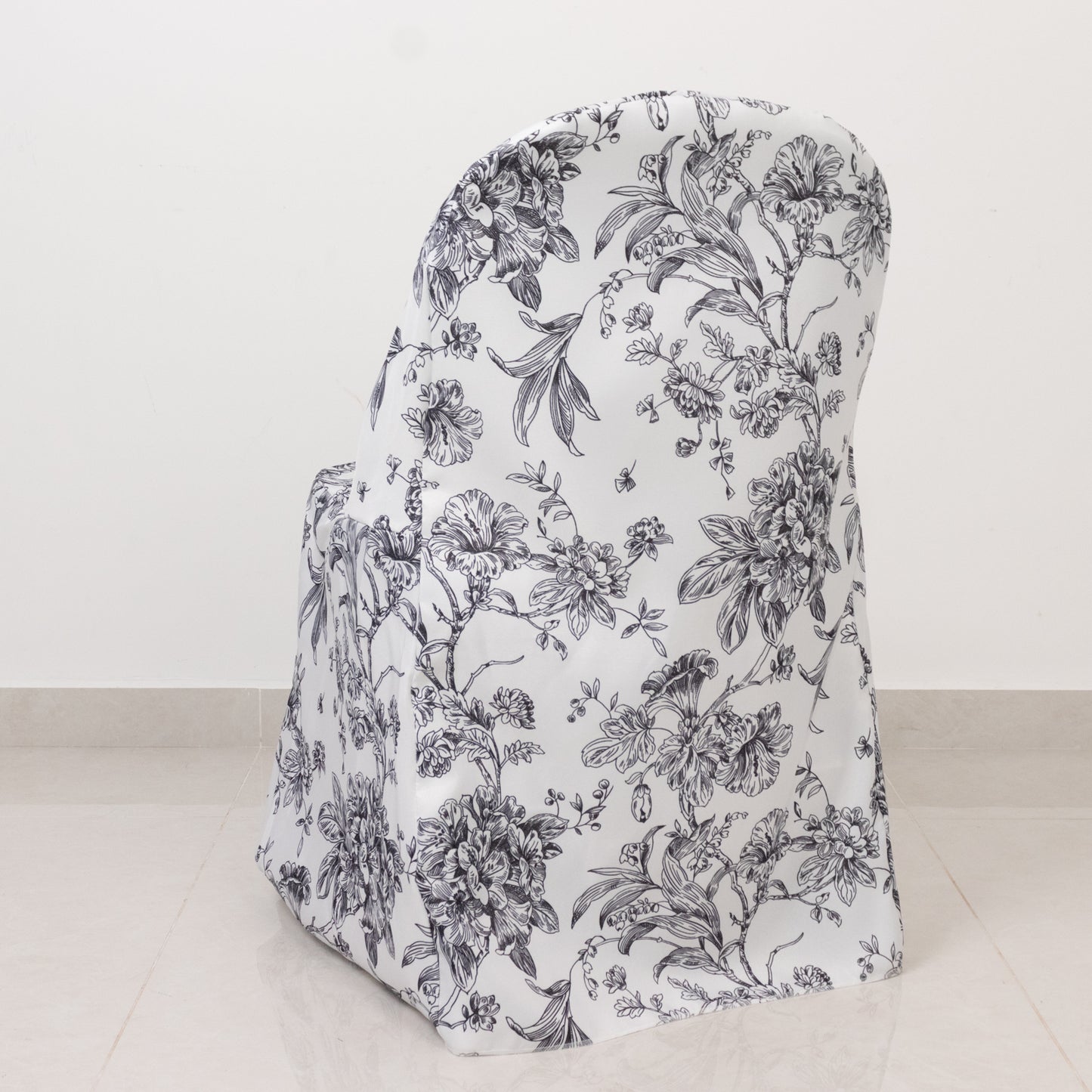 White and black French toile pattern chair cover for folding chairs.