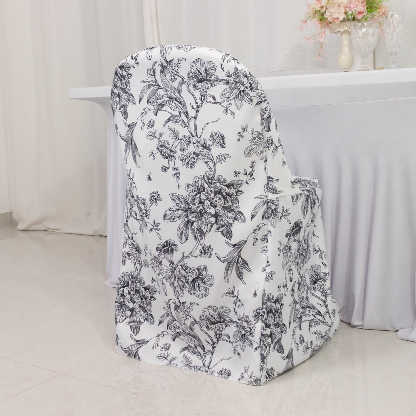 White and black French toile pattern chair cover for folding chairs.