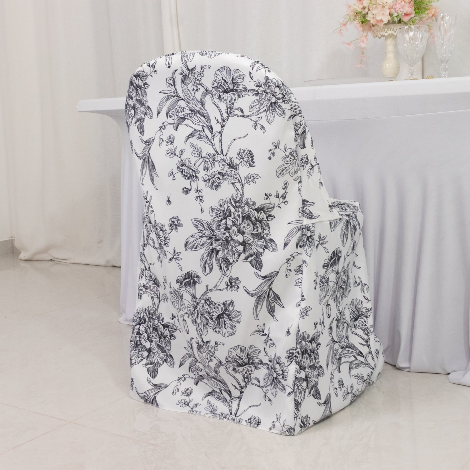 White and black French toile pattern chair cover for folding chairs.