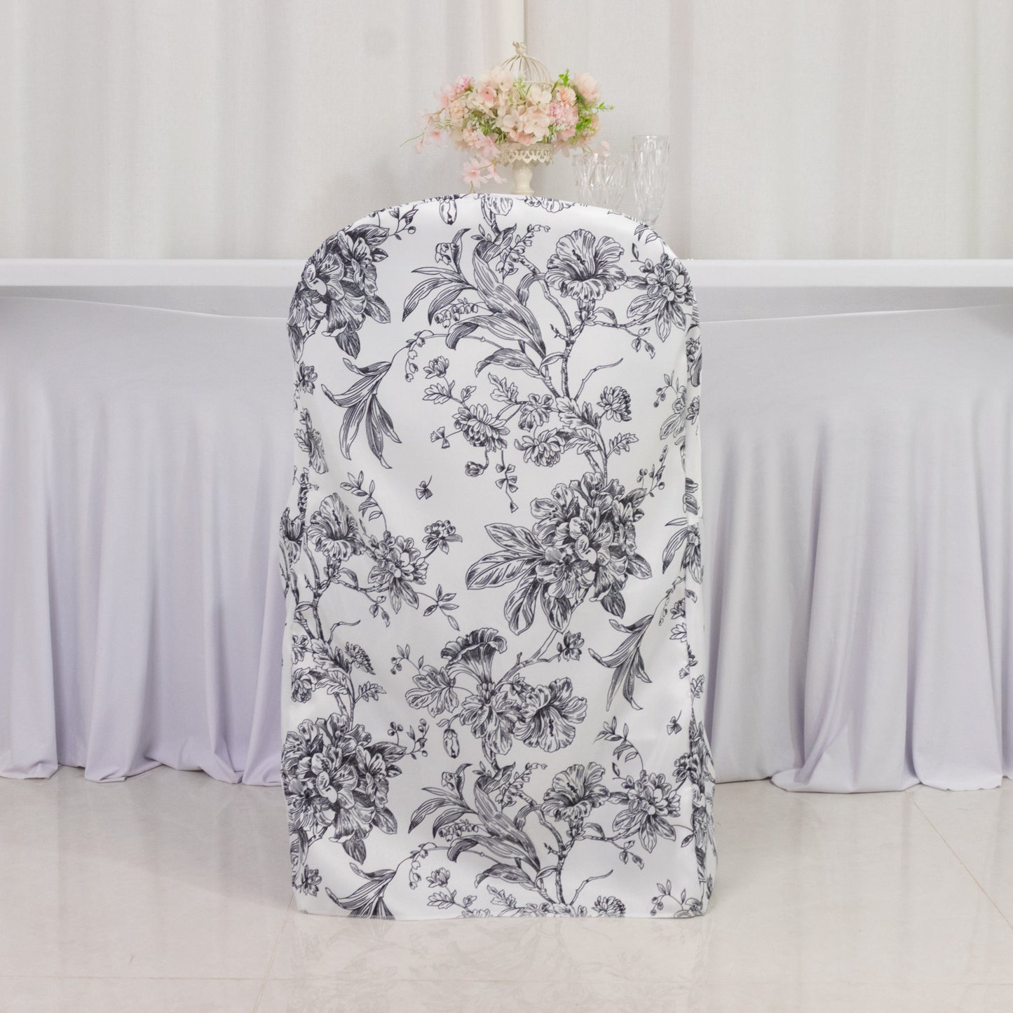 White and black French toile pattern chair cover for folding chairs.