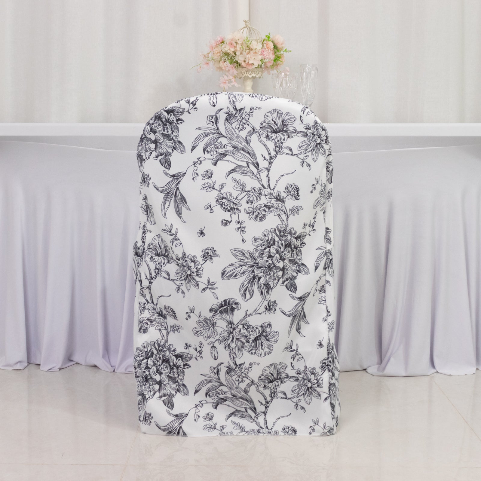White and black French toile pattern chair cover for folding chairs.