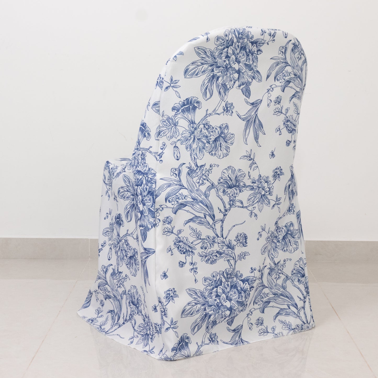 White blue chair cover with French toile pattern on a folding chair.