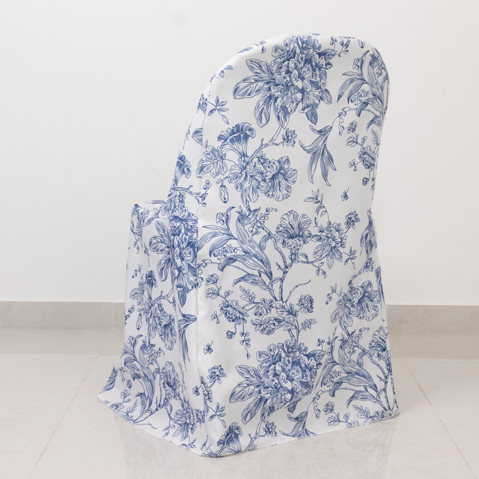 White blue chair cover with French toile pattern on a folding chair.