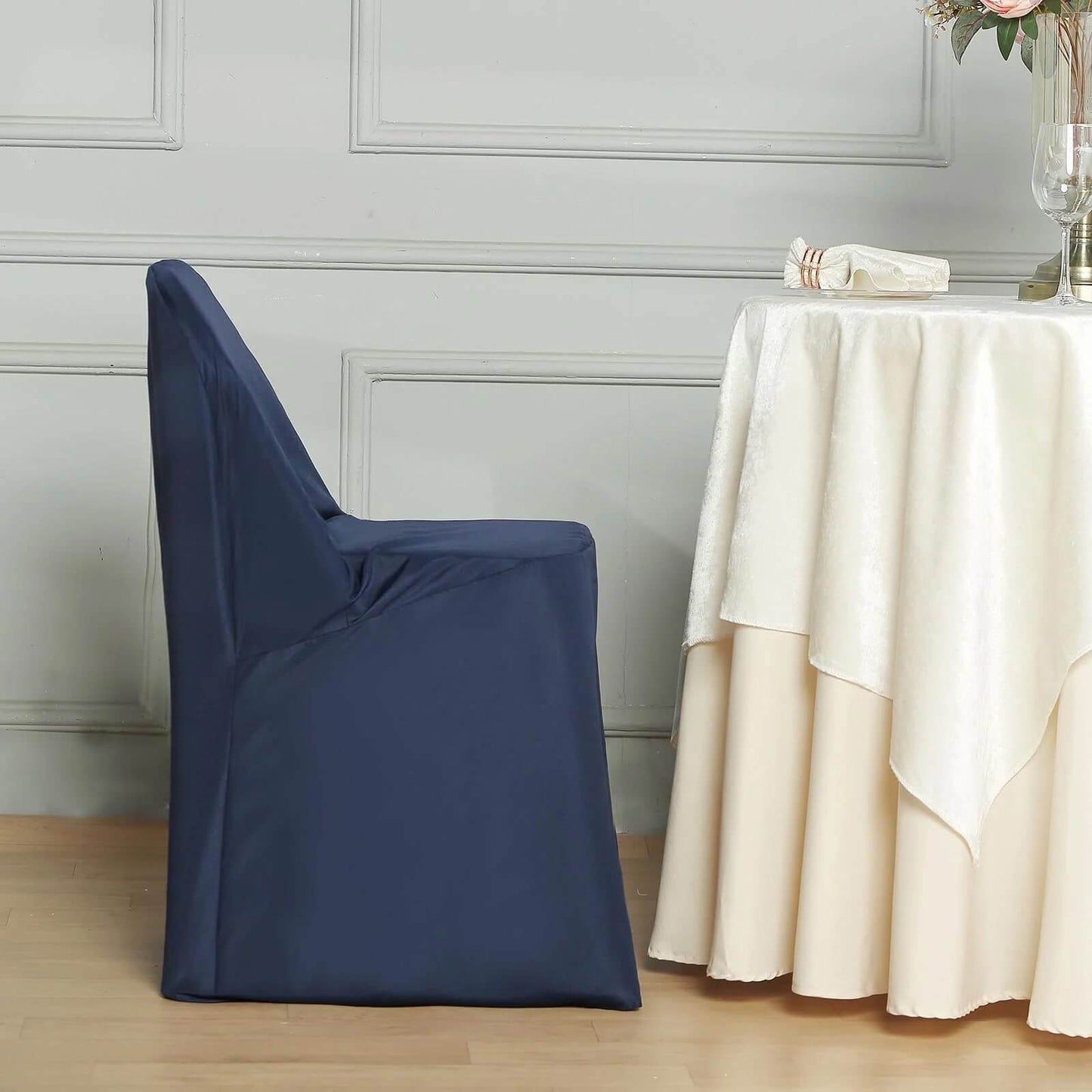 Navy blue polyester folding chair cover on a chair.