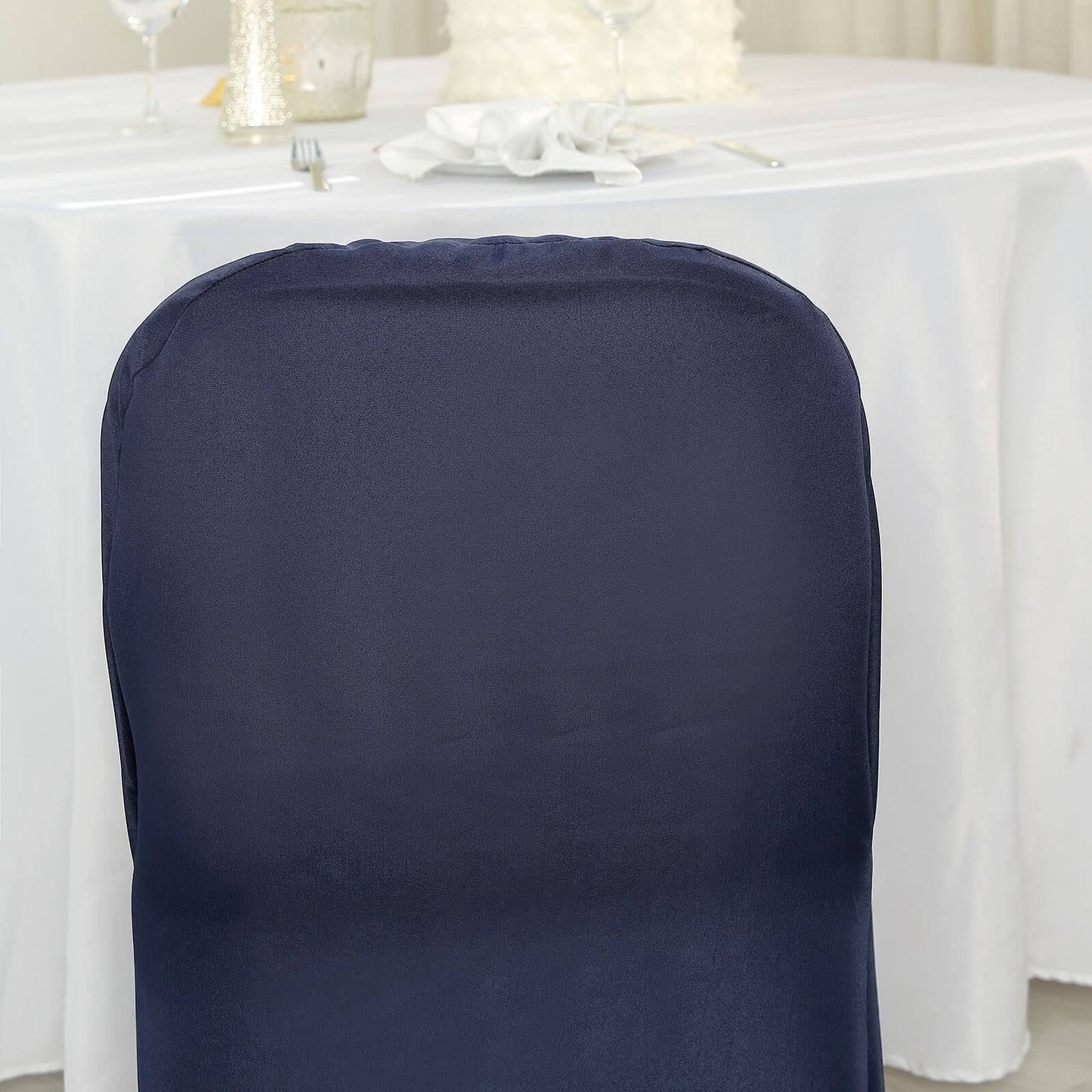 Navy blue polyester folding chair cover on a table setting.