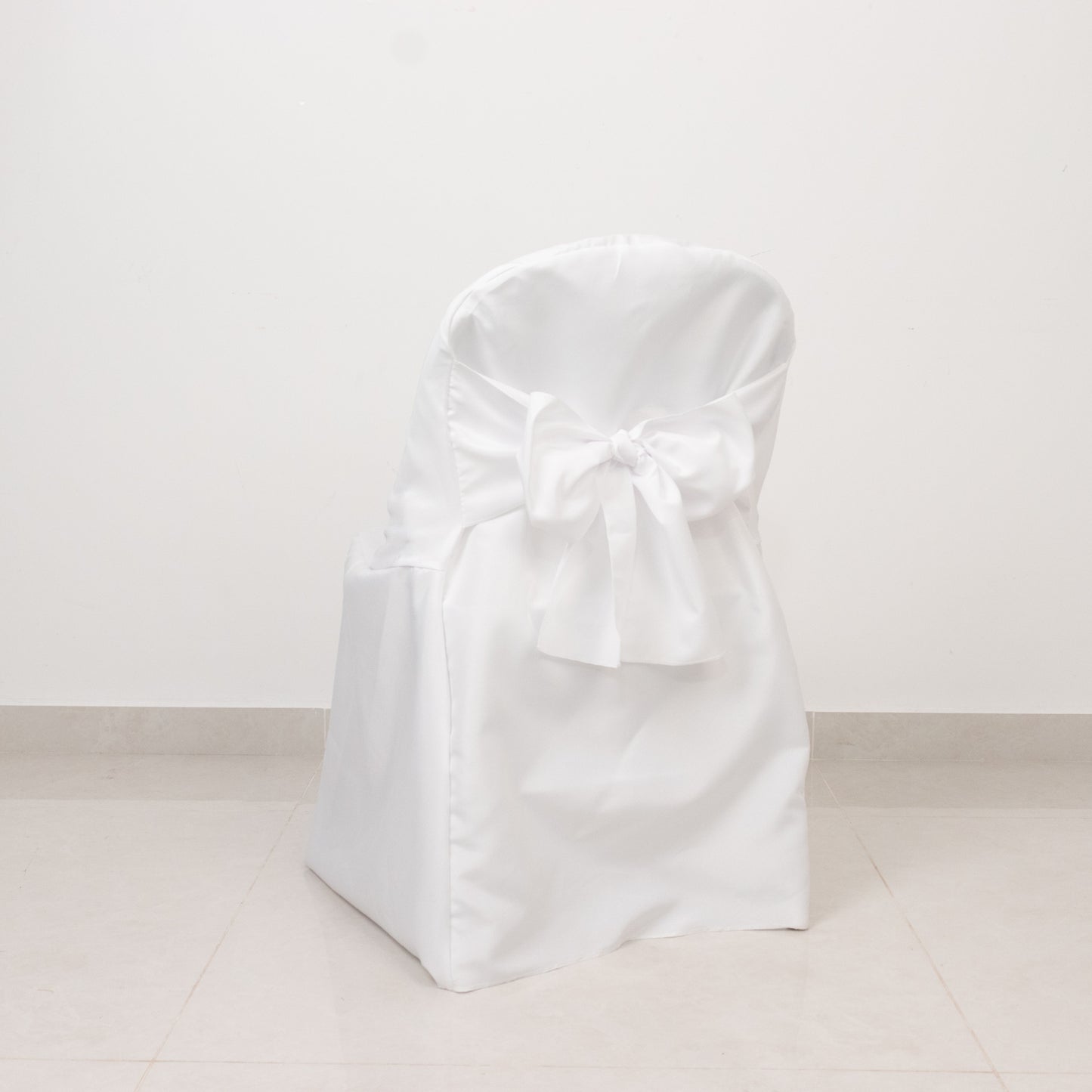 White polyester slip-on folding chair cover with attached sash.
