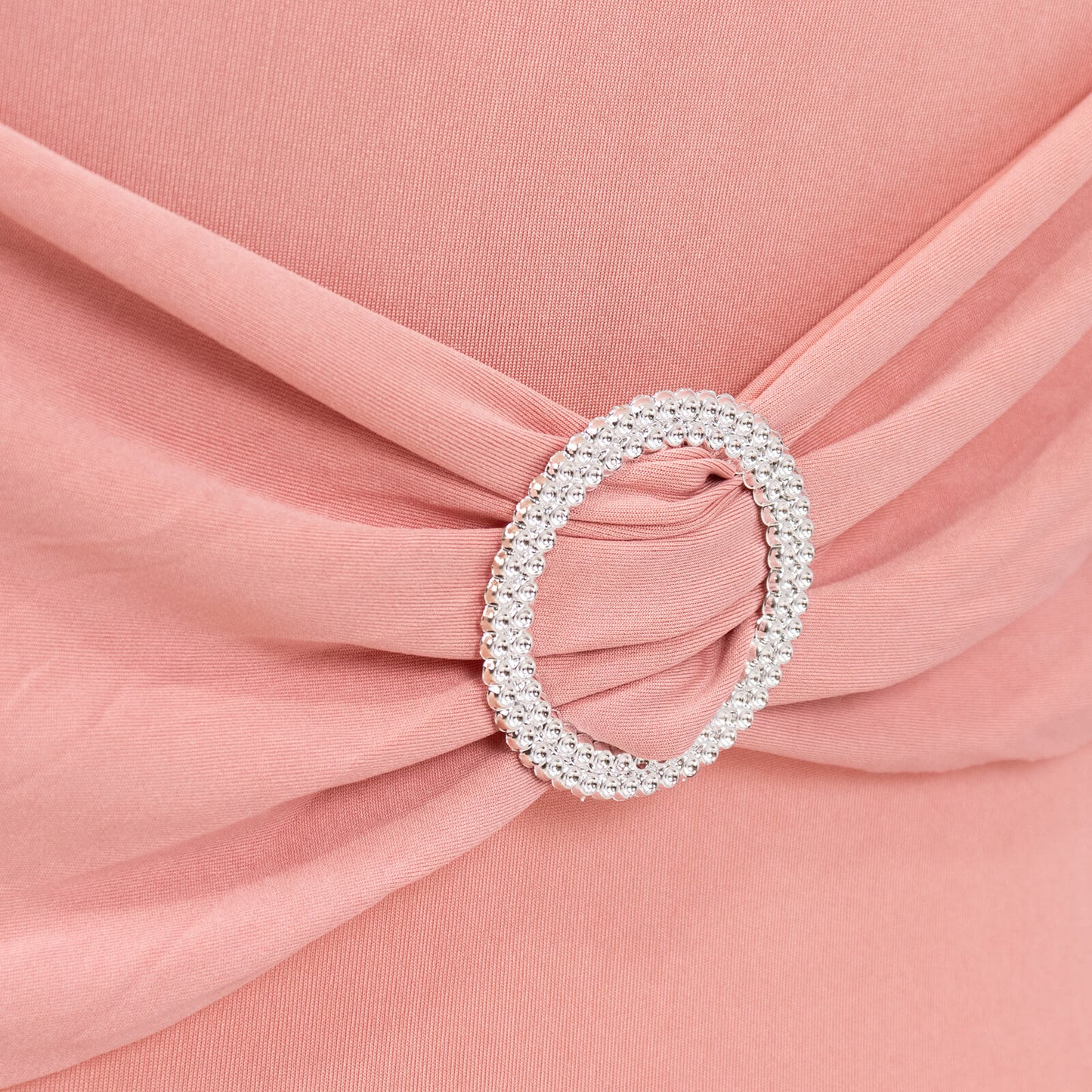Blush spandex chair cover with silver rhinestone buckle detail.