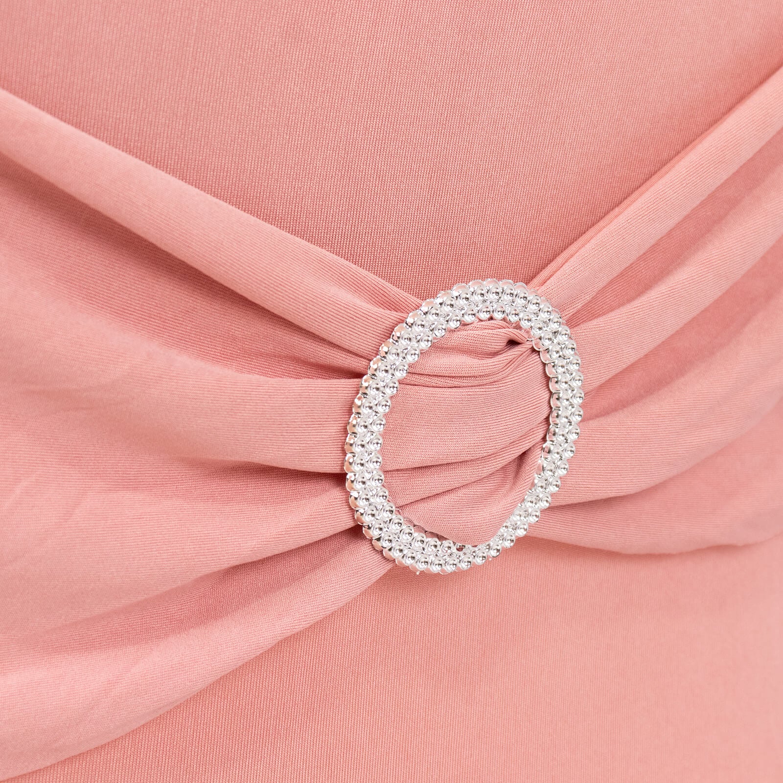 Blush spandex chair cover with silver rhinestone buckle detail.