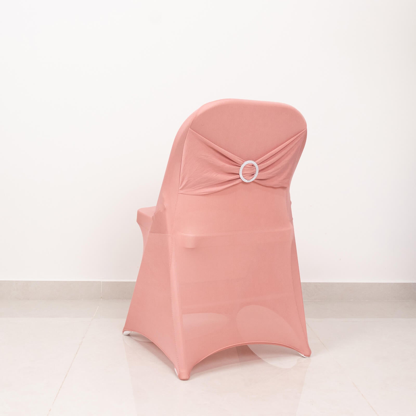 Blush spandex folding chair cover with silver rhinestone sash.