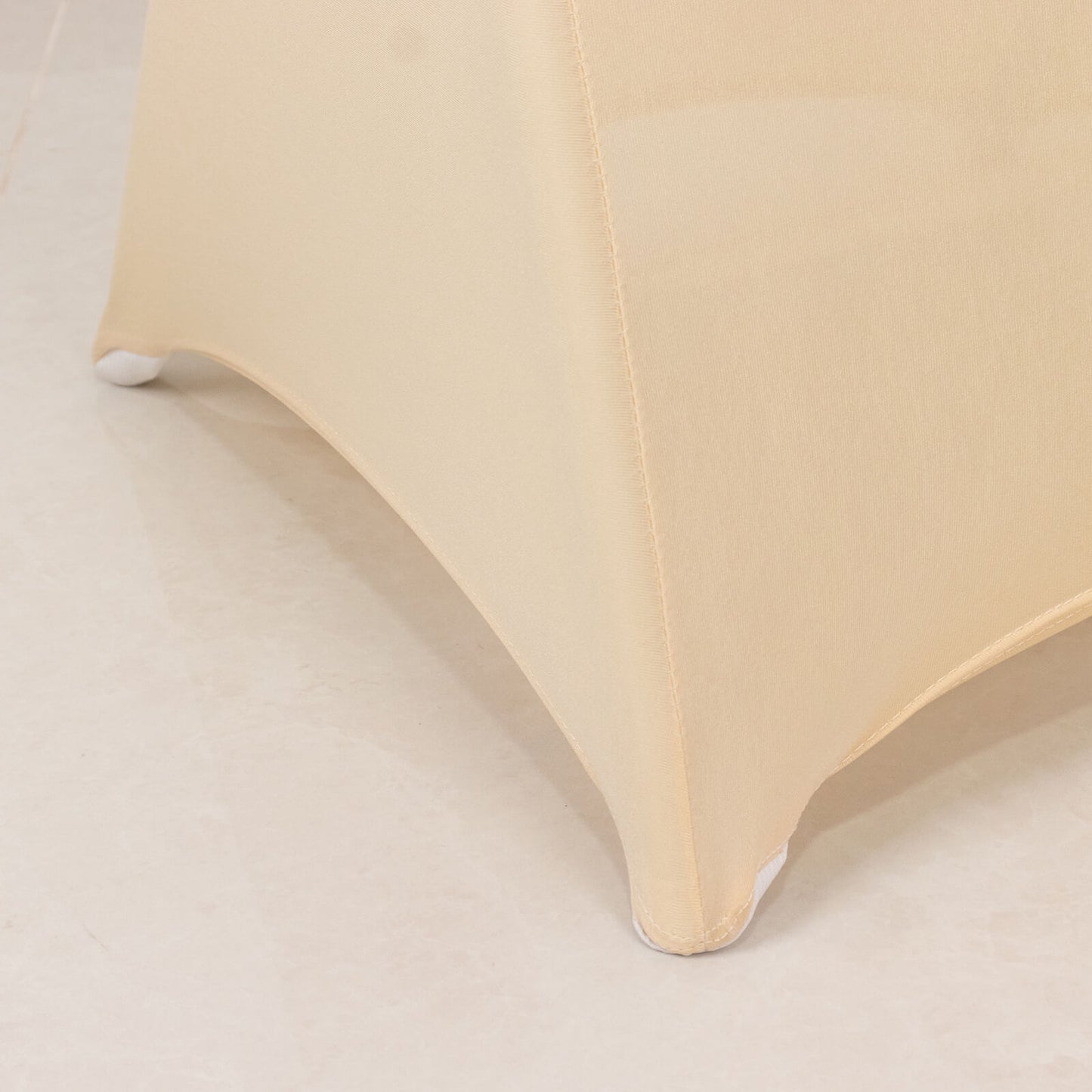 Beige spandex folding chair cover with rhinestone sash.