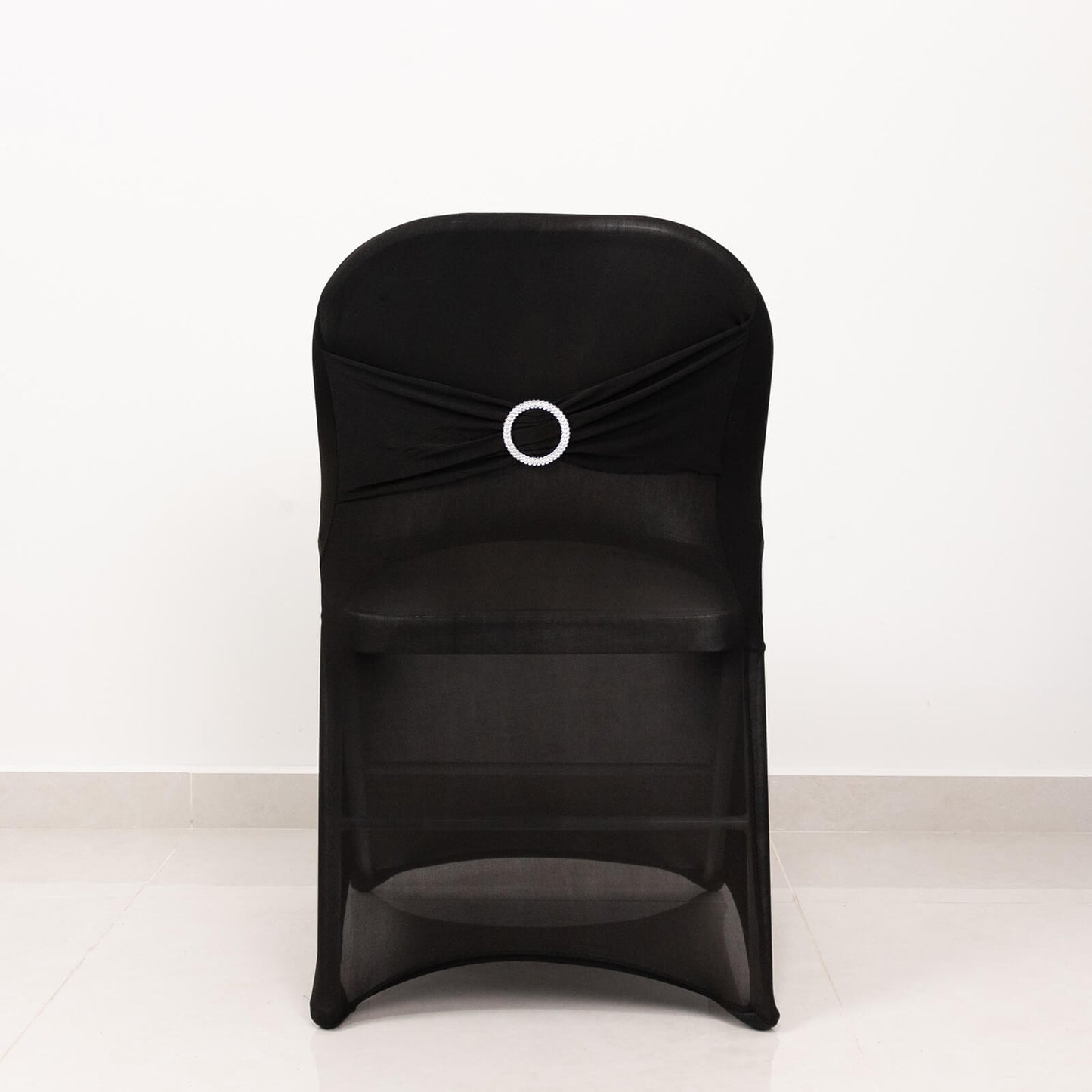Black spandex folding chair cover with silver rhinestone sash.