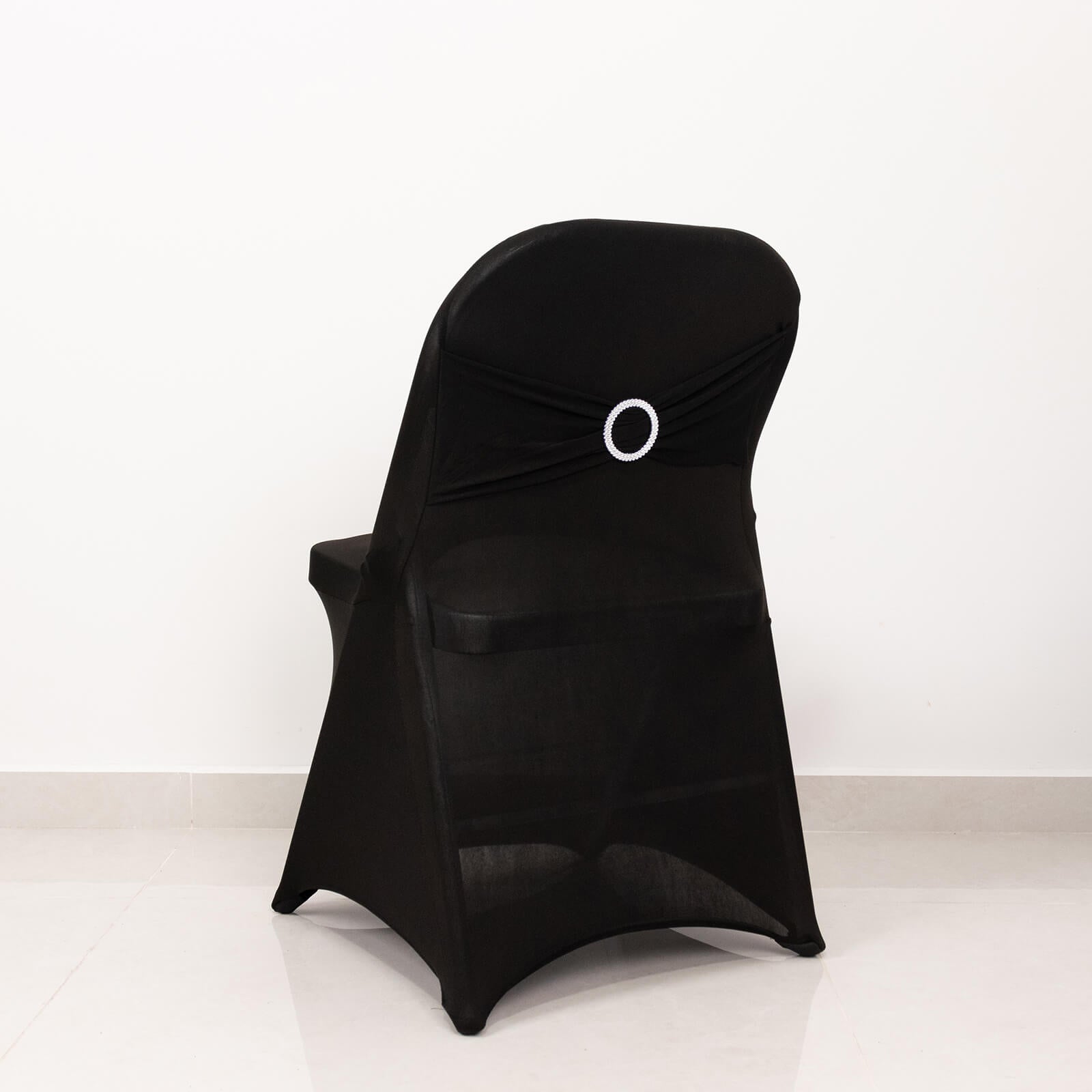Black spandex folding chair cover with silver rhinestone sash.