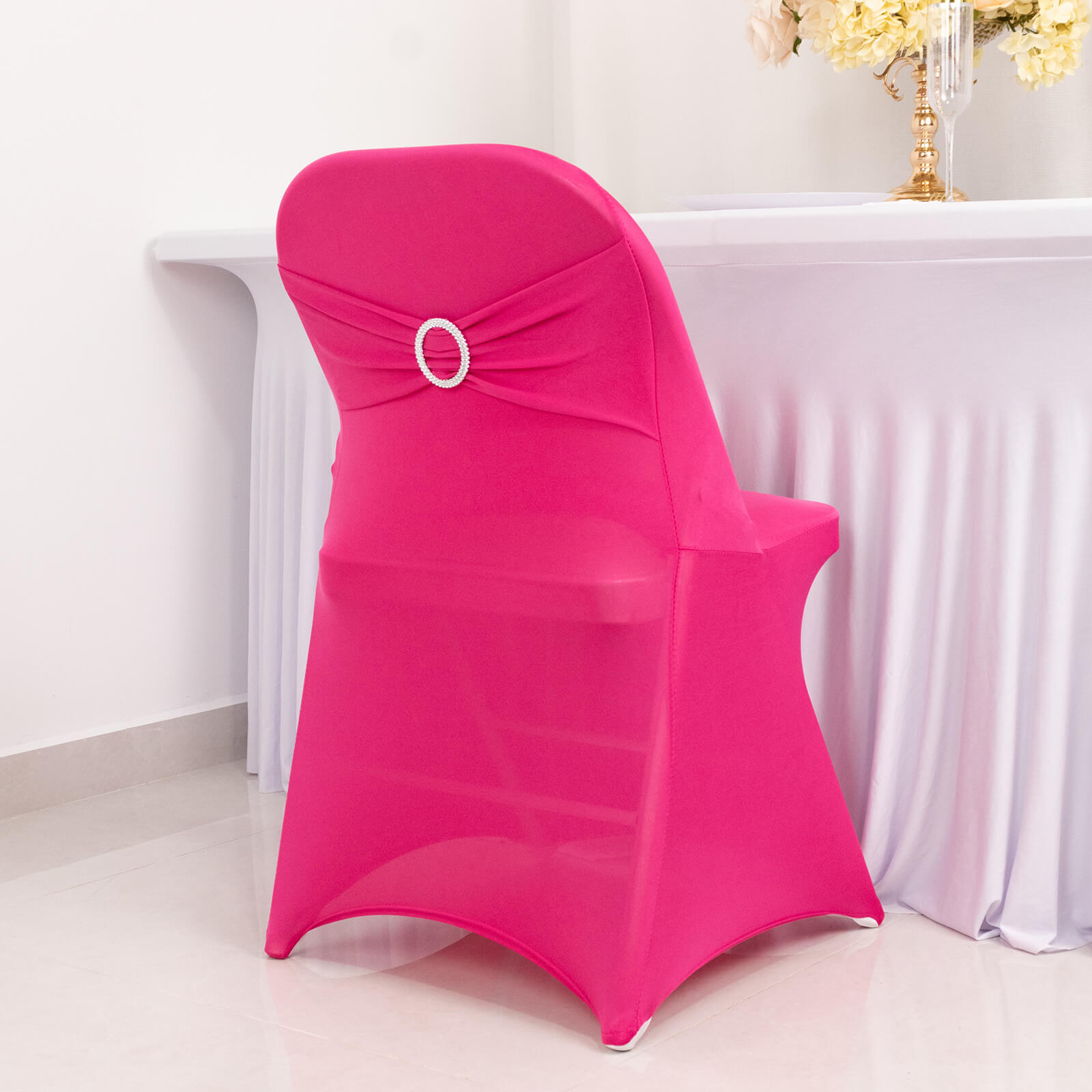 Fuchsia spandex folding chair cover with rhinestone sash band.