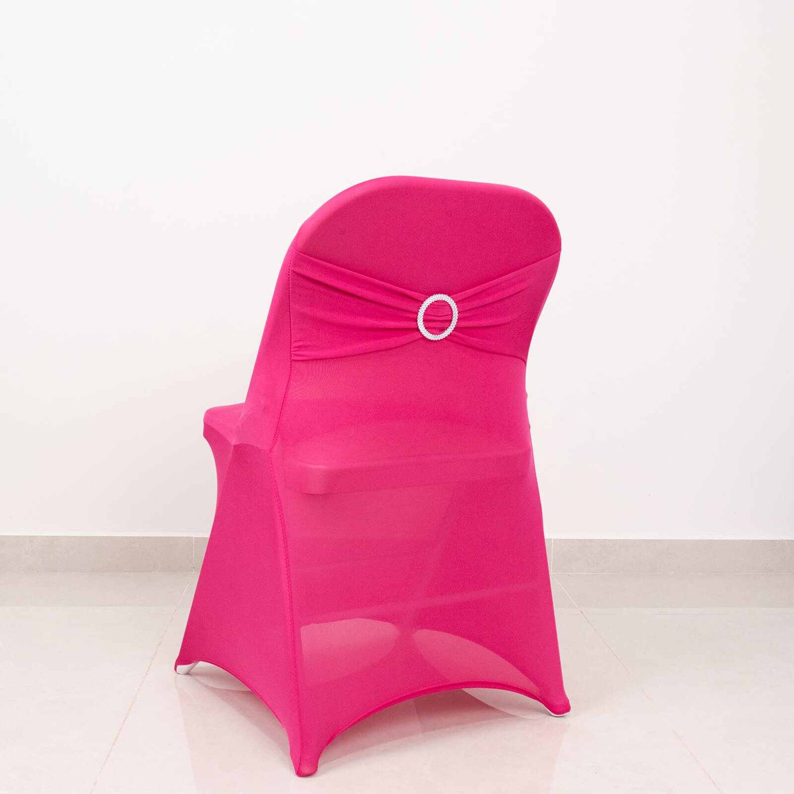 Fuchsia spandex folding chair cover with rhinestone buckle sash.