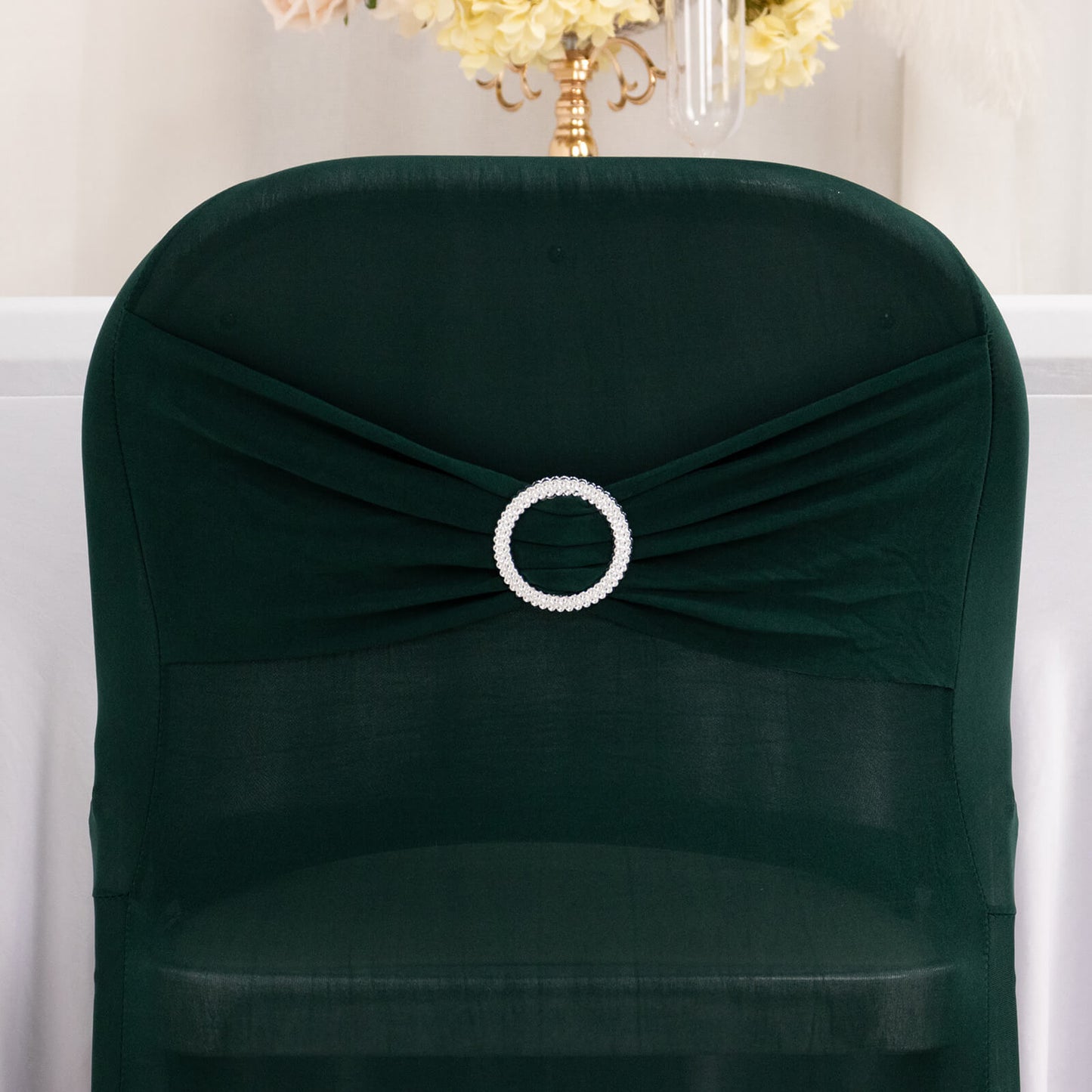 Emerald green spandex folding chair cover with rhinestone buckle.