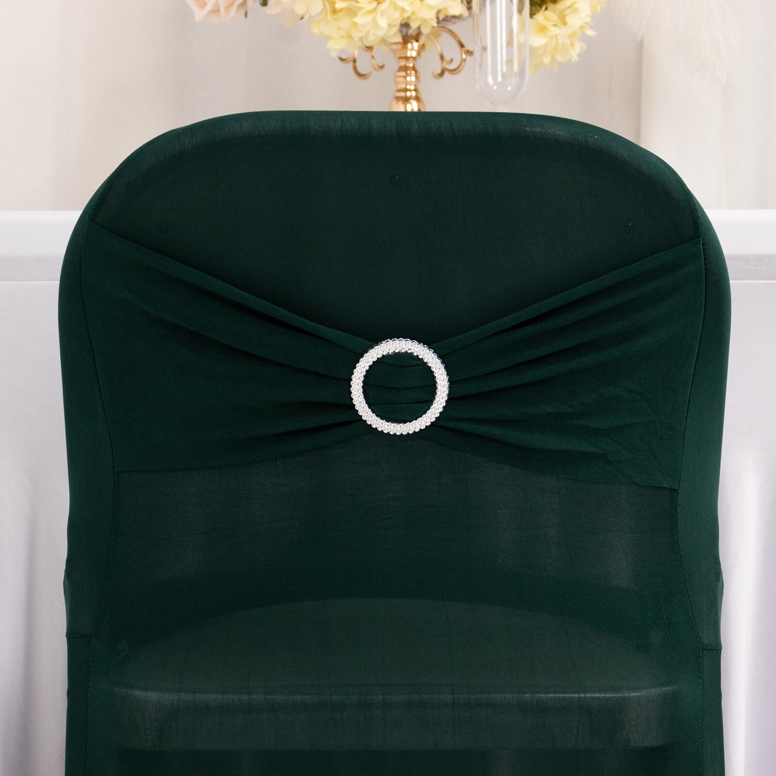 Emerald green spandex folding chair cover with rhinestone buckle.