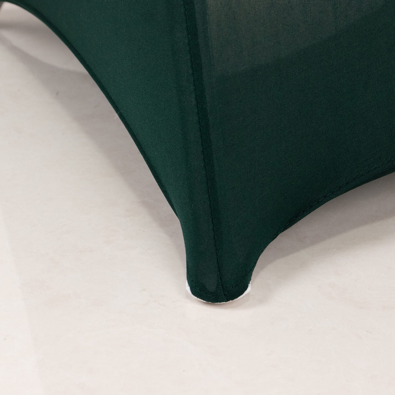 Emerald green spandex folding chair cover with silver rhinestone sash.