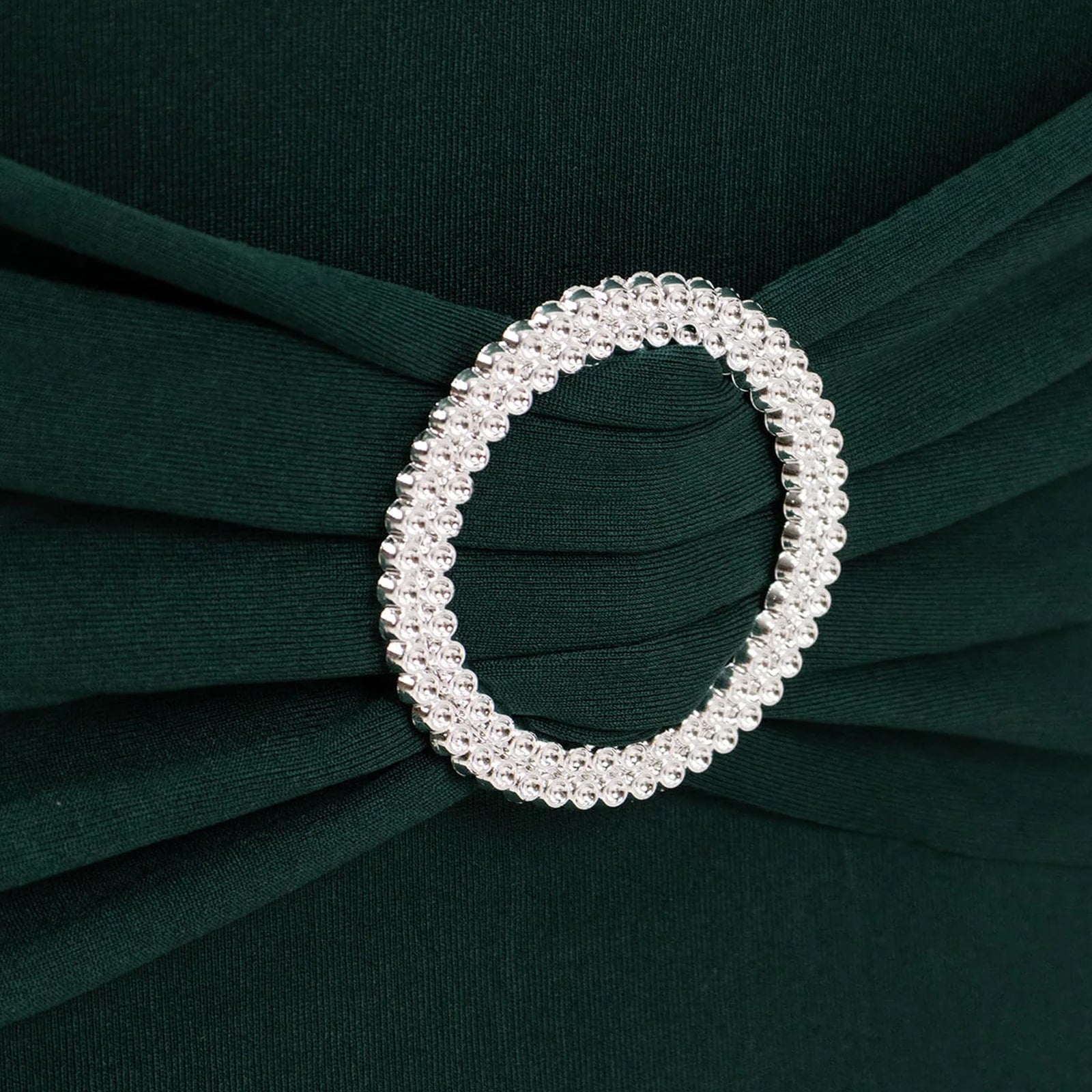 Emerald green chair cover with silver rhinestone buckle detail. #whtbkgd