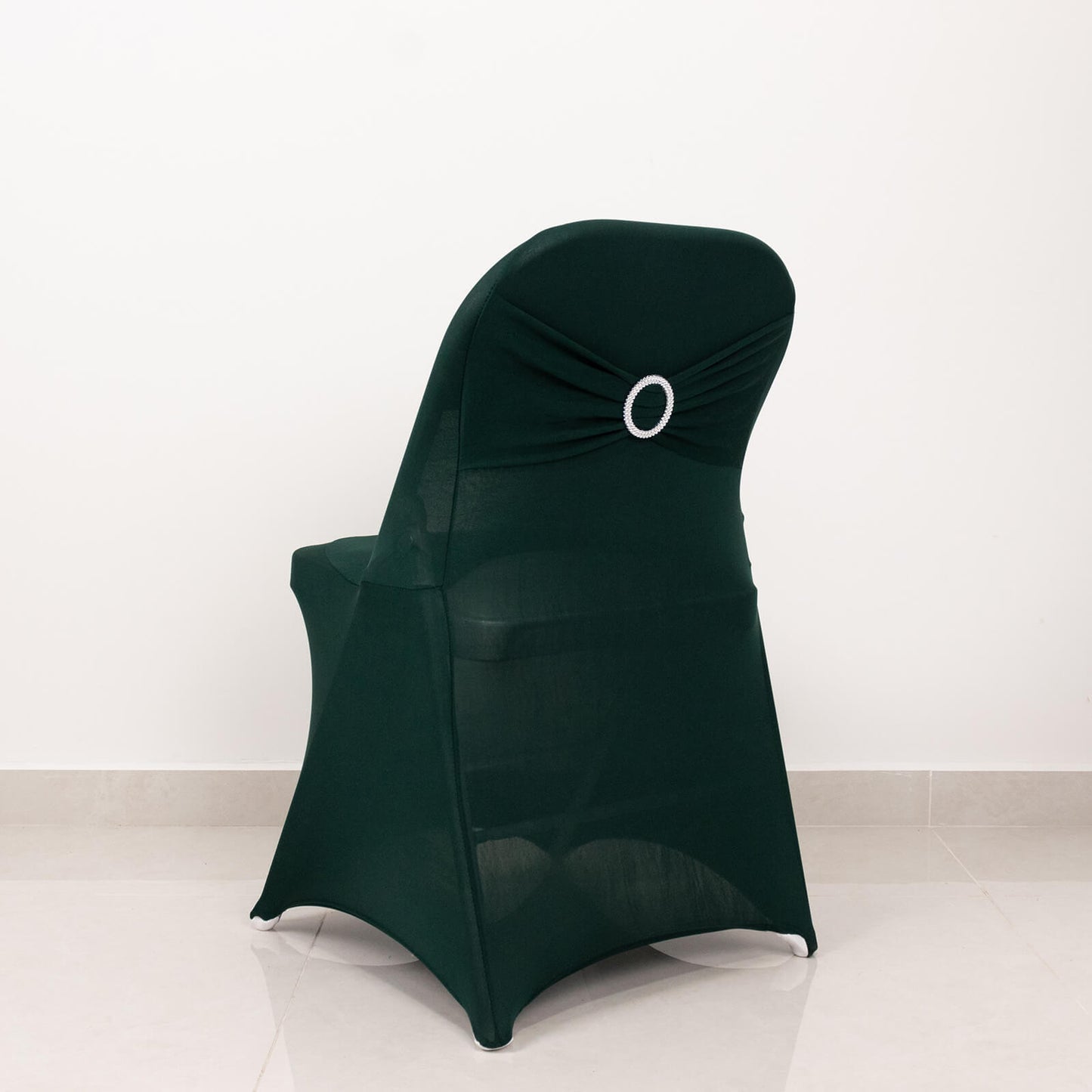 Emerald green spandex folding chair cover with silver rhinestone sash.
