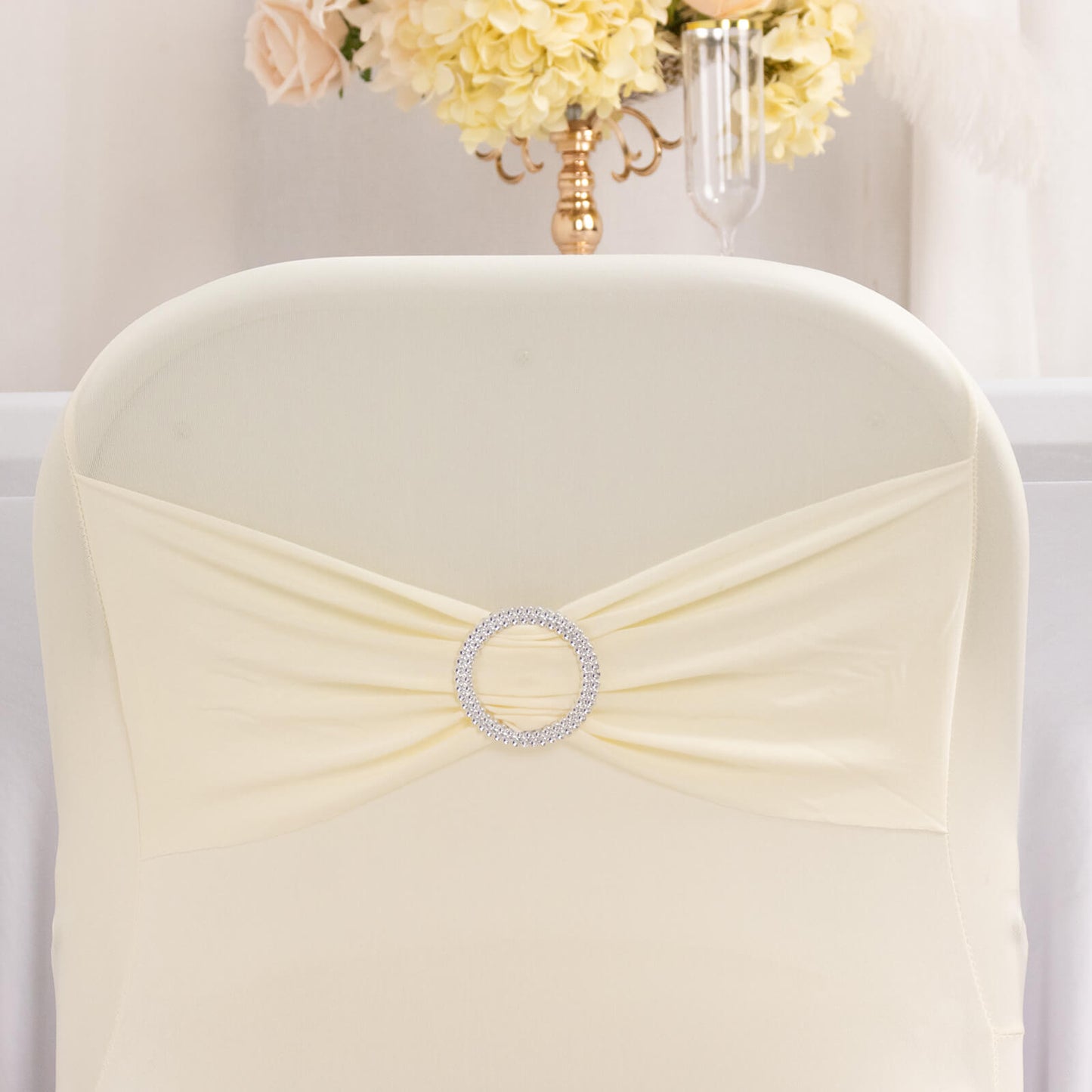 Ivory spandex chair cover with silver rhinestone sash band.