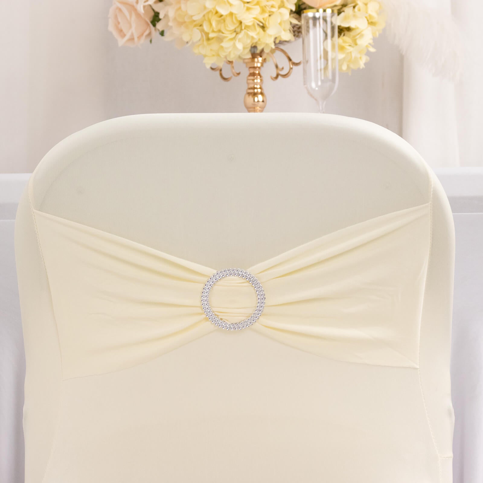 Ivory spandex chair cover with silver rhinestone sash band.
