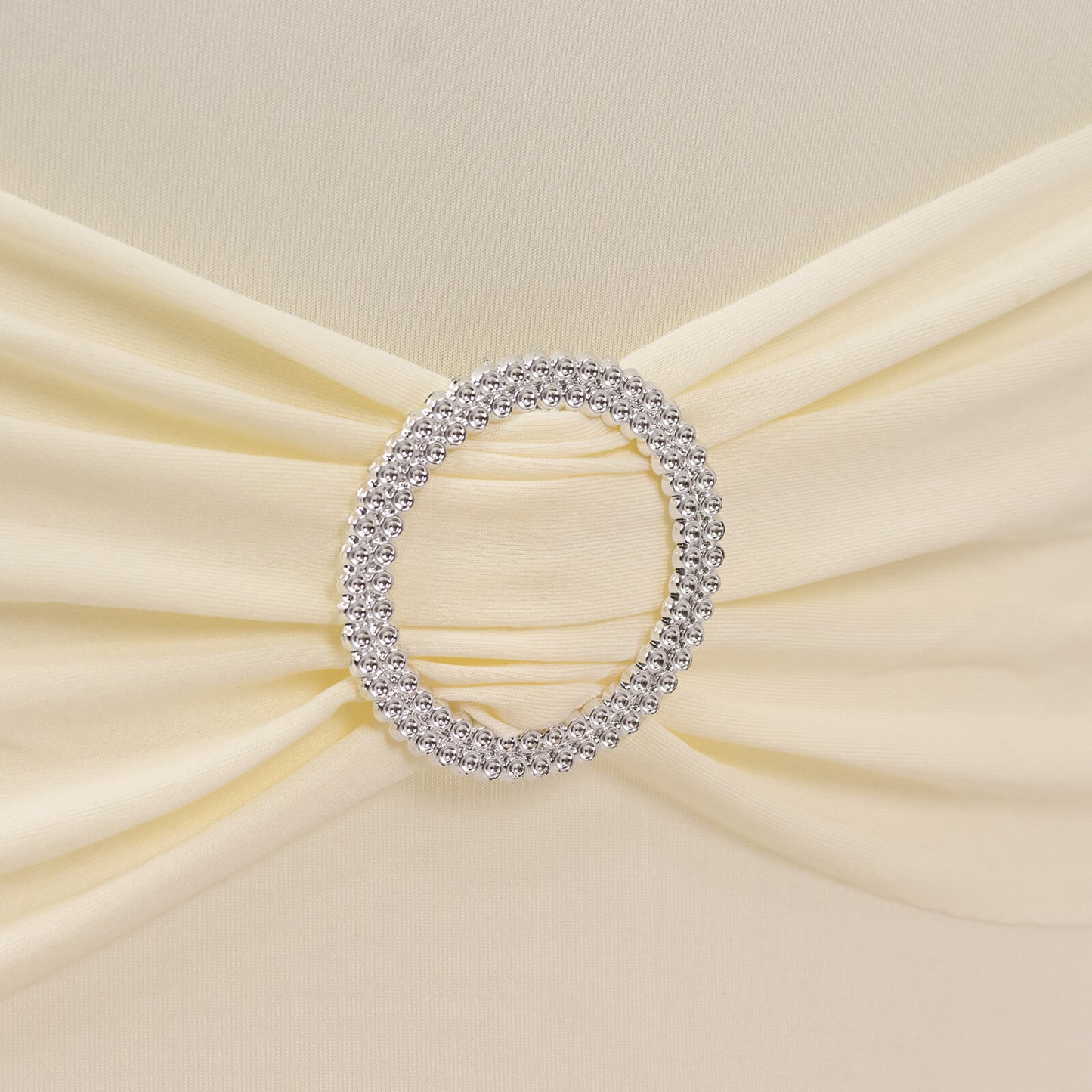 Ivory spandex chair cover with silver rhinestone buckled sash.