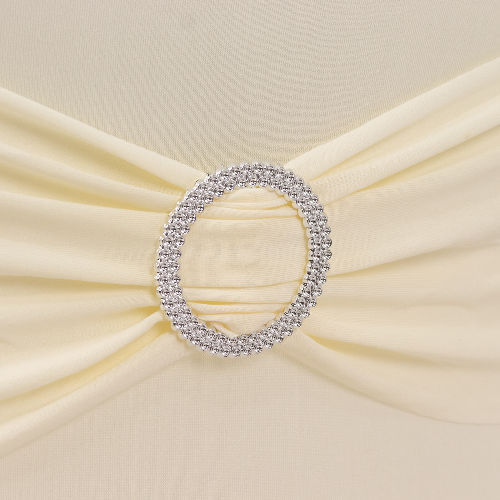 Ivory spandex chair cover with silver rhinestone buckled sash.