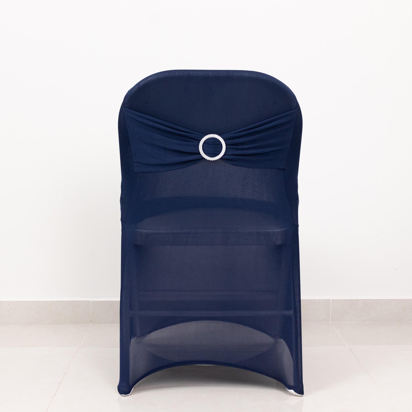 Navy blue spandex folding chair cover with rhinestone buckle.