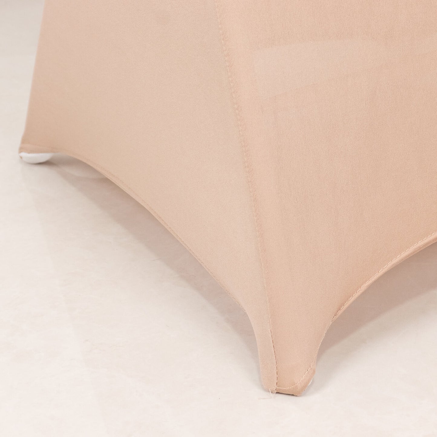 Nude spandex chair cover with silver rhinestone sash detail.
