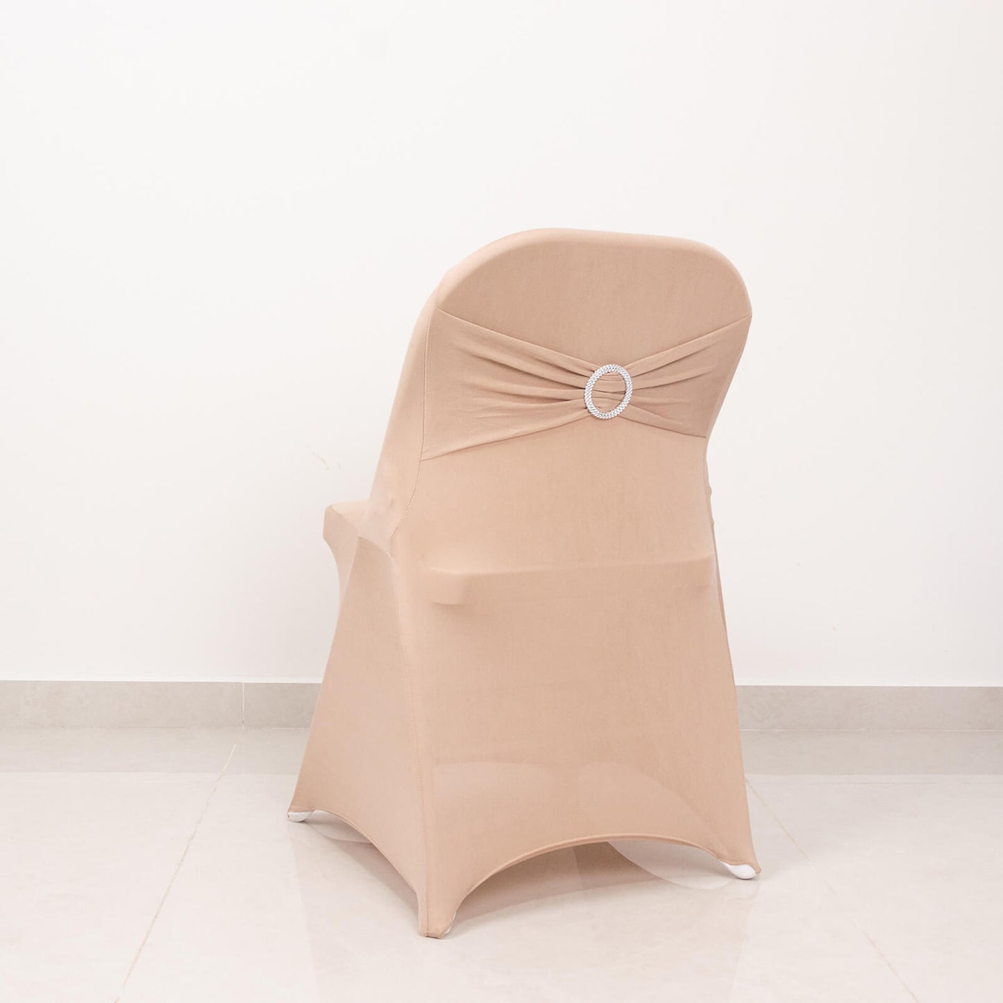Nude spandex folding chair cover with silver rhinestone sash.