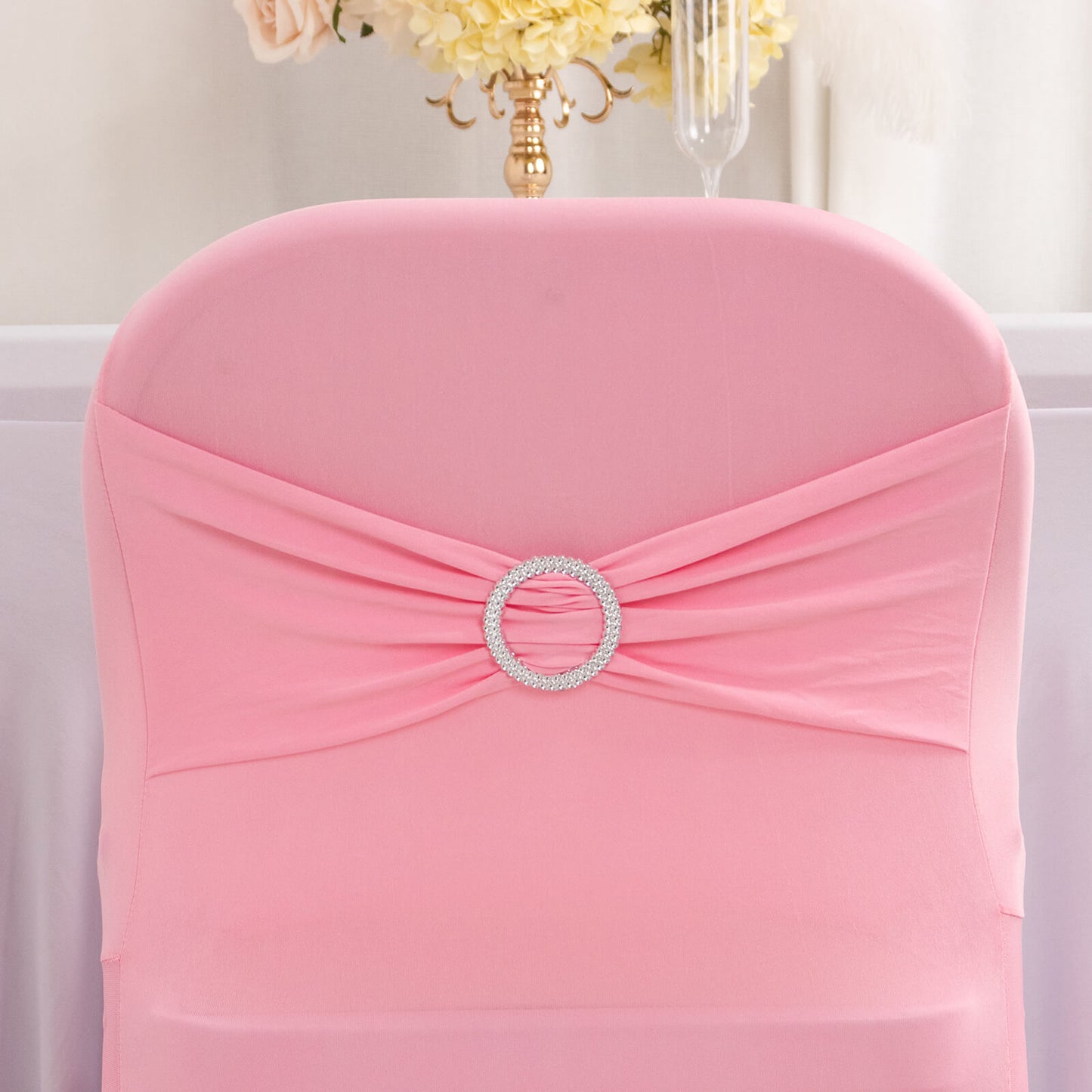 Pink spandex folding chair cover with silver rhinestone sash.