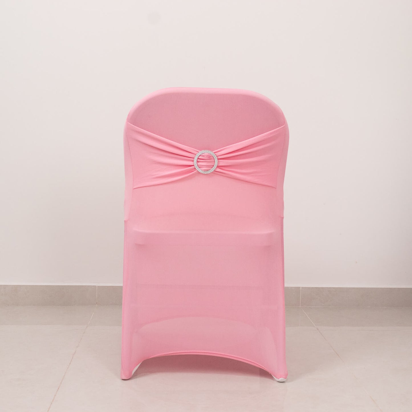 Pink folding chair cover with silver rhinestone sash.