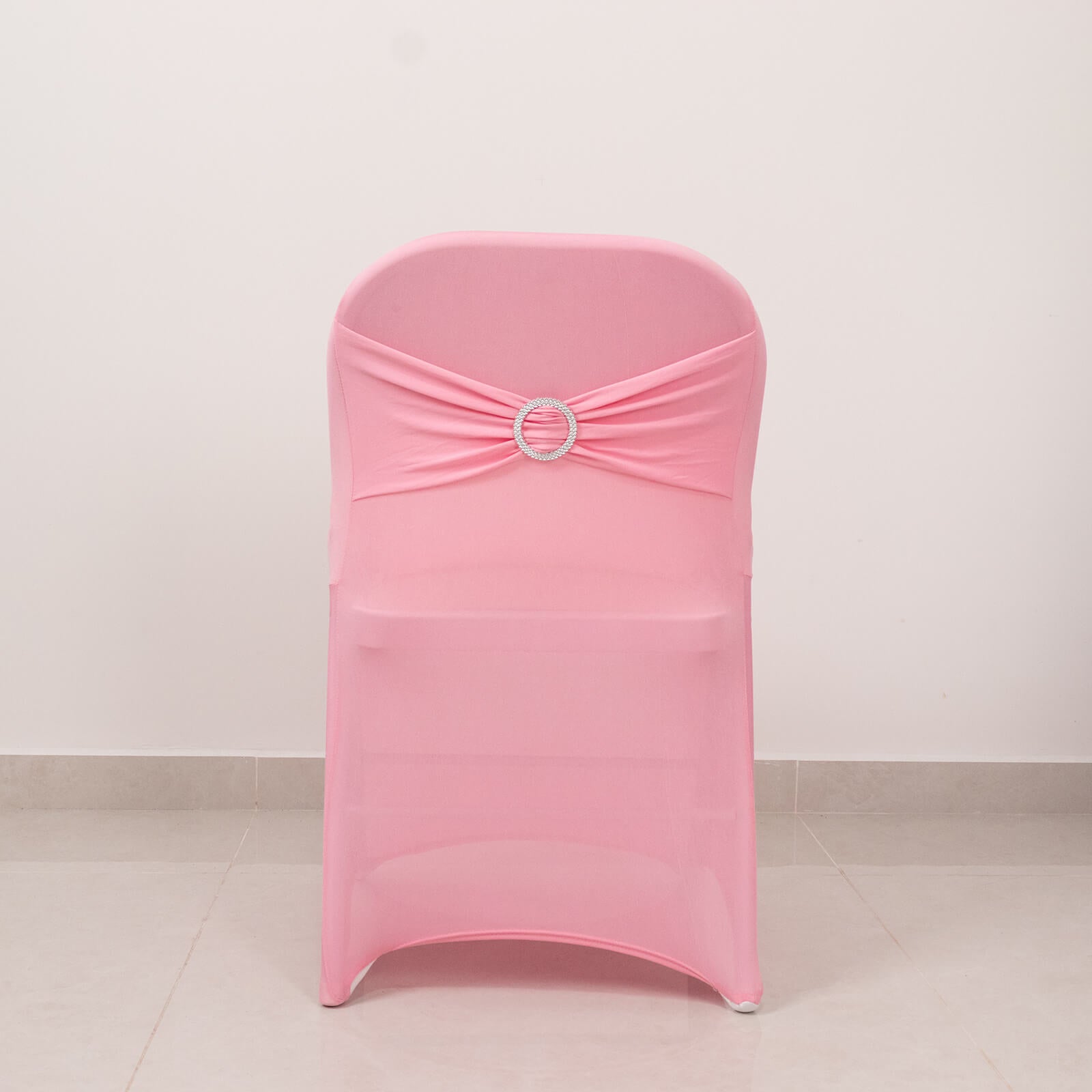 Pink folding chair cover with silver rhinestone sash.