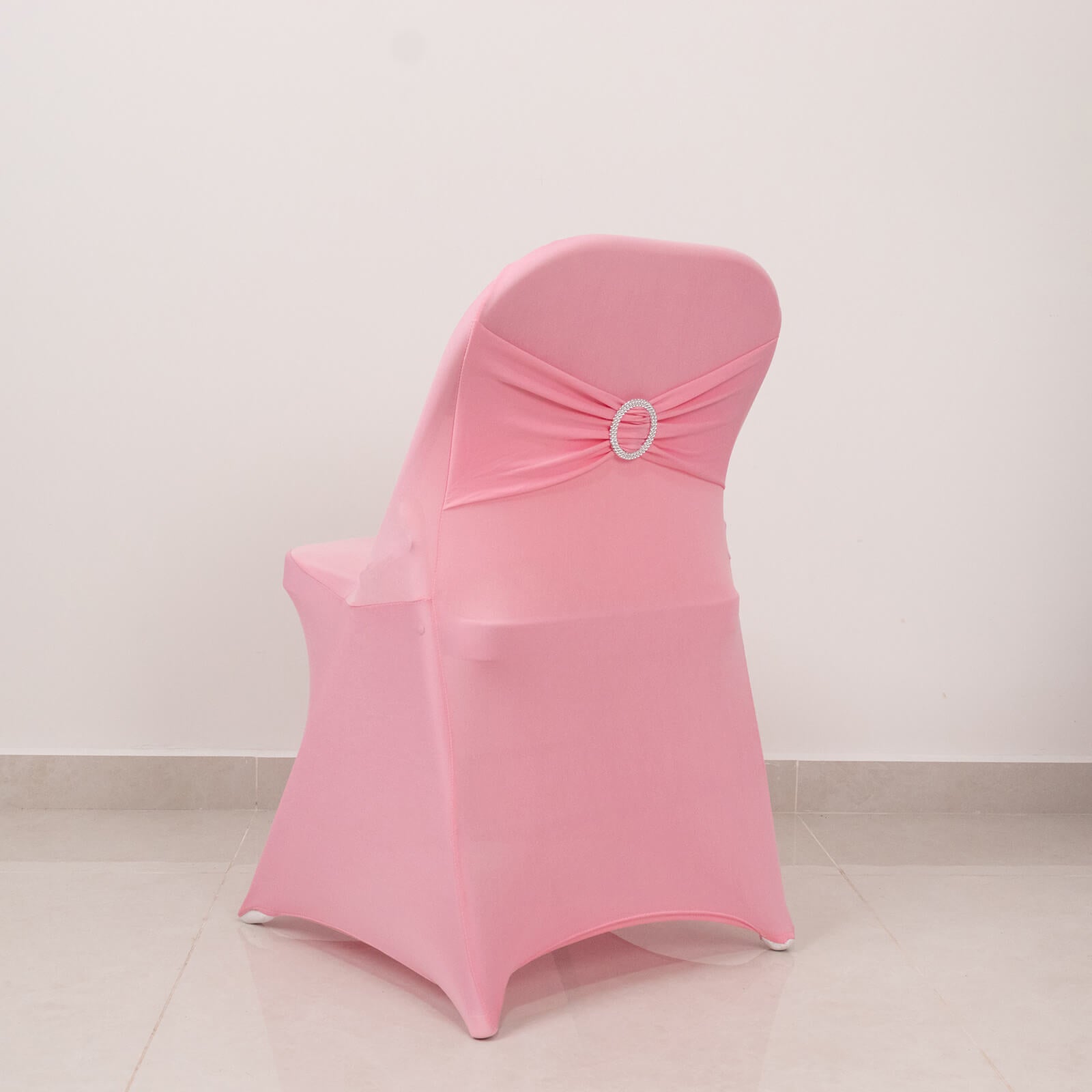 Pink spandex chair cover with silver rhinestone sash band.