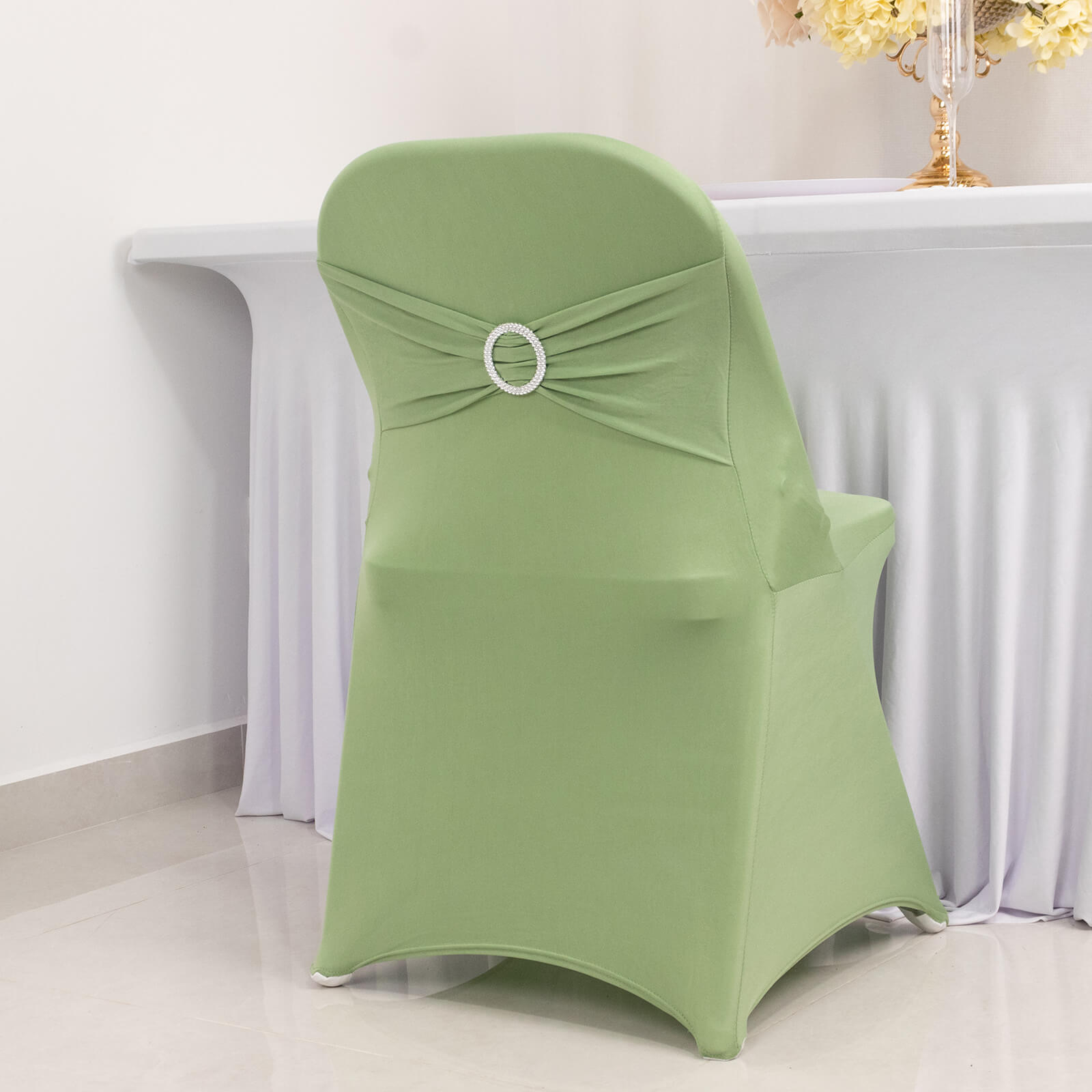 Sage green spandex folding chair cover with silver rhinestone sash.