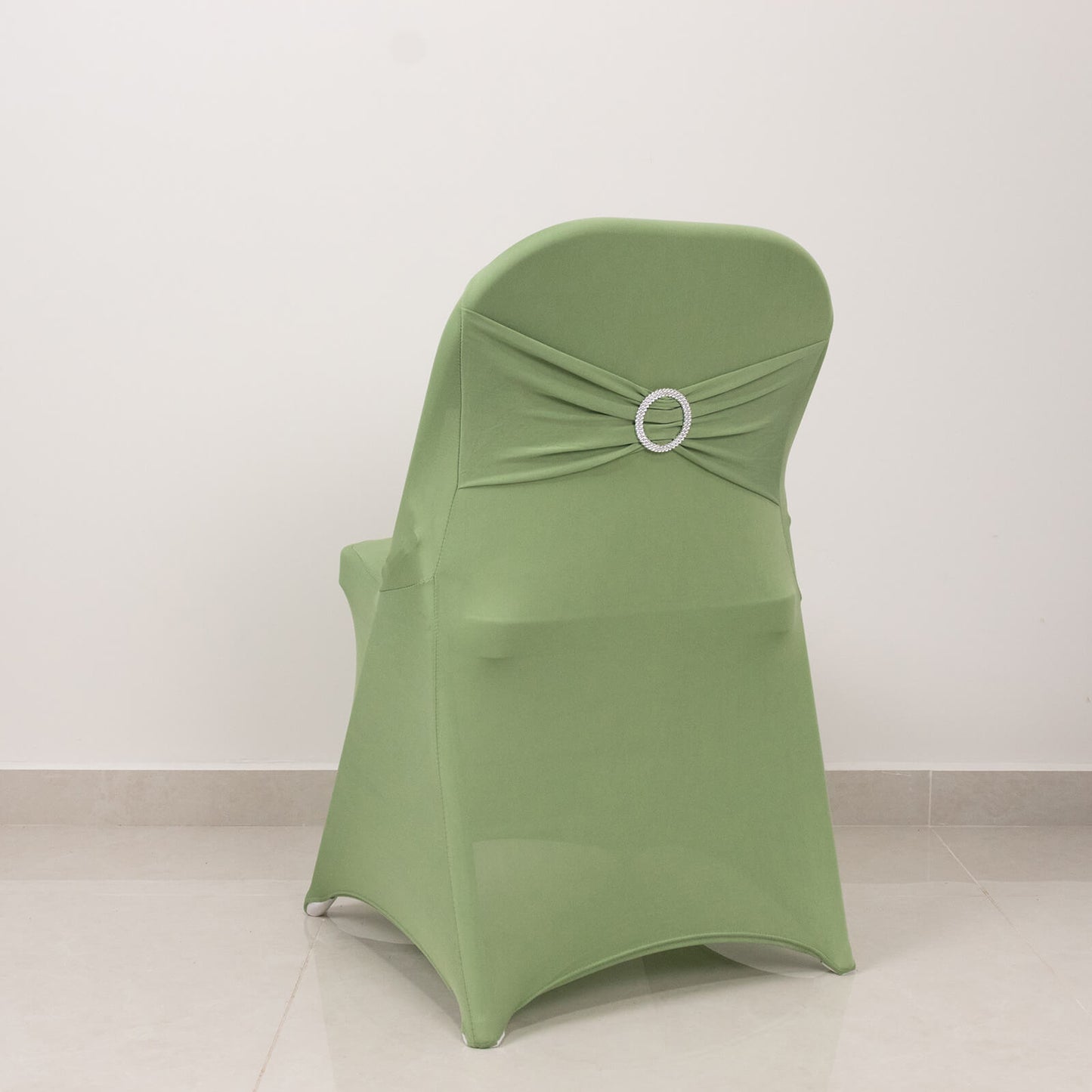 Sage green spandex folding chair cover with rhinestone sash.