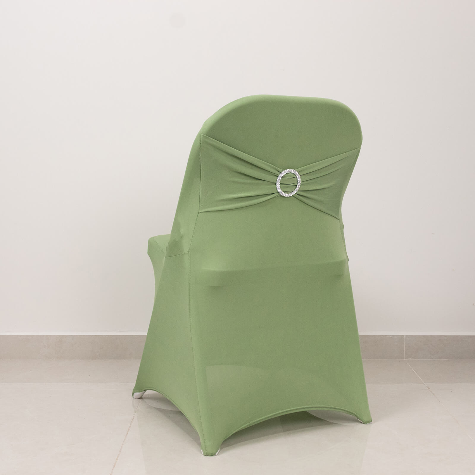 Sage green spandex folding chair cover with rhinestone sash.