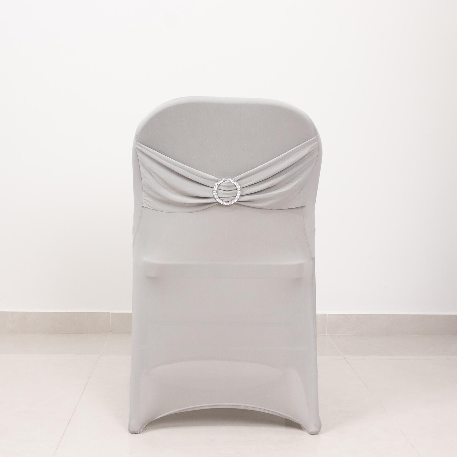 Silver spandex chair cover with rhinestone buckled sash band.