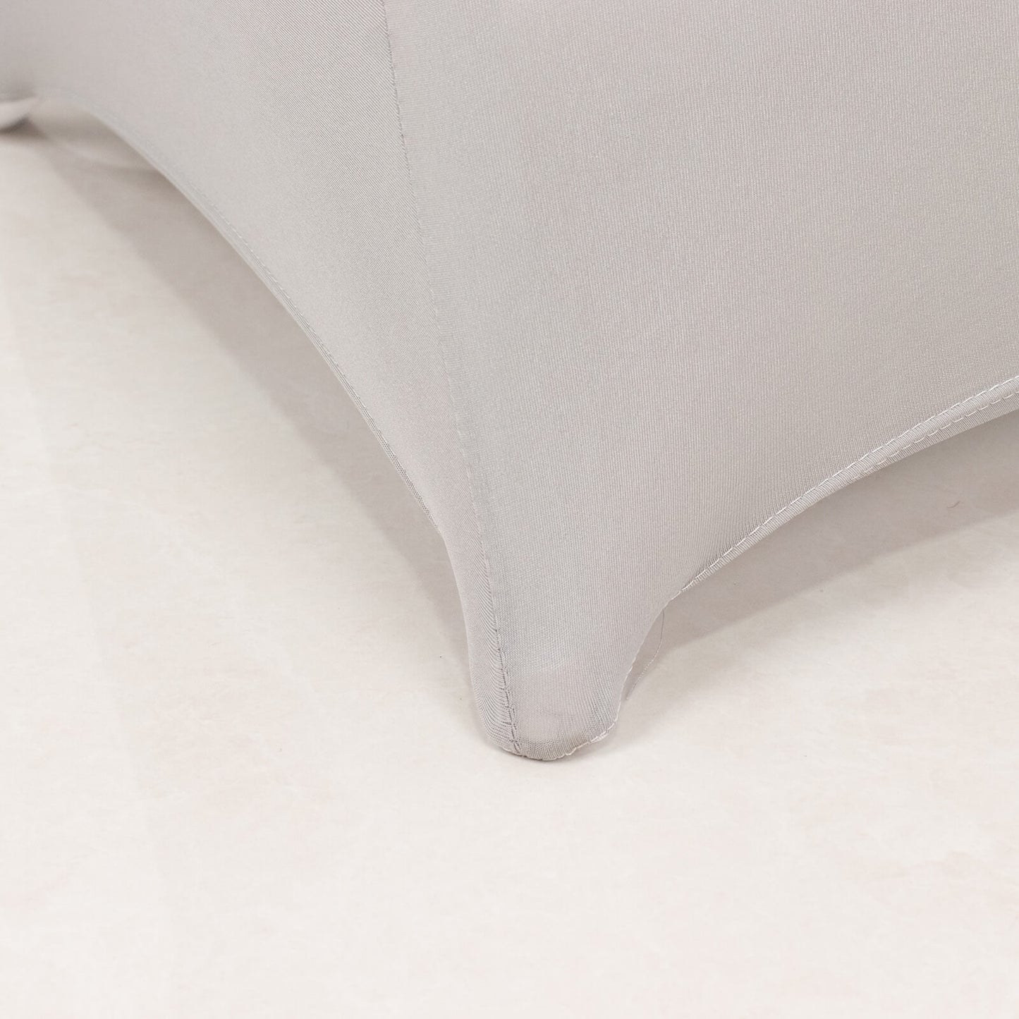 Silver spandex folding chair cover with rhinestone sash detail.