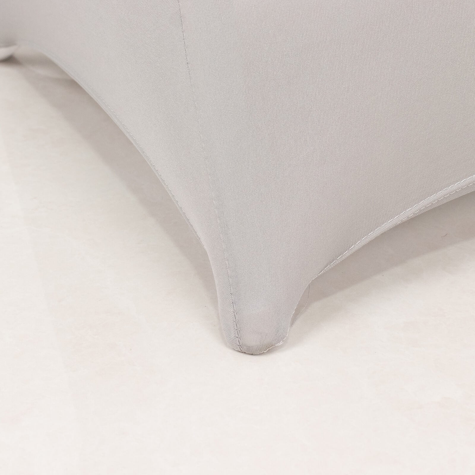 Silver spandex folding chair cover with rhinestone sash detail.