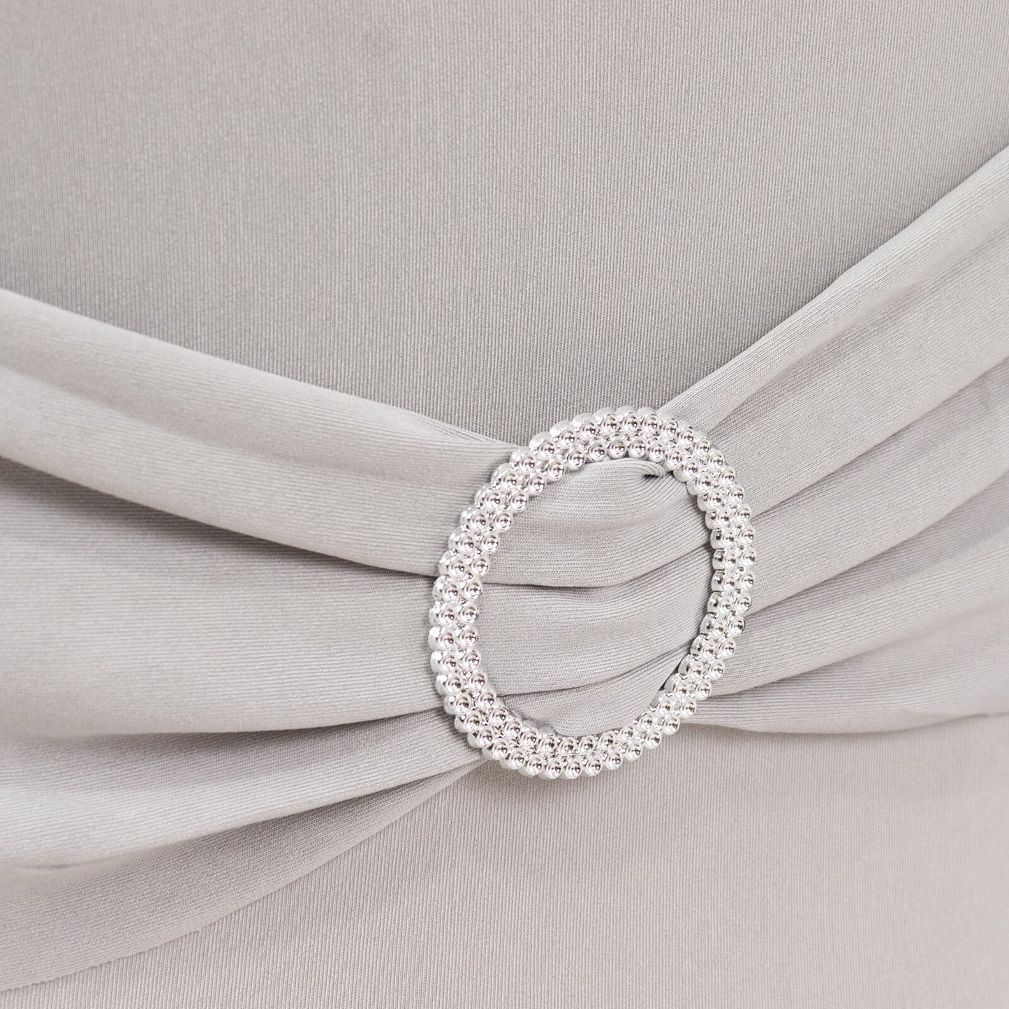 Silver spandex chair cover with rhinestone buckle detail.