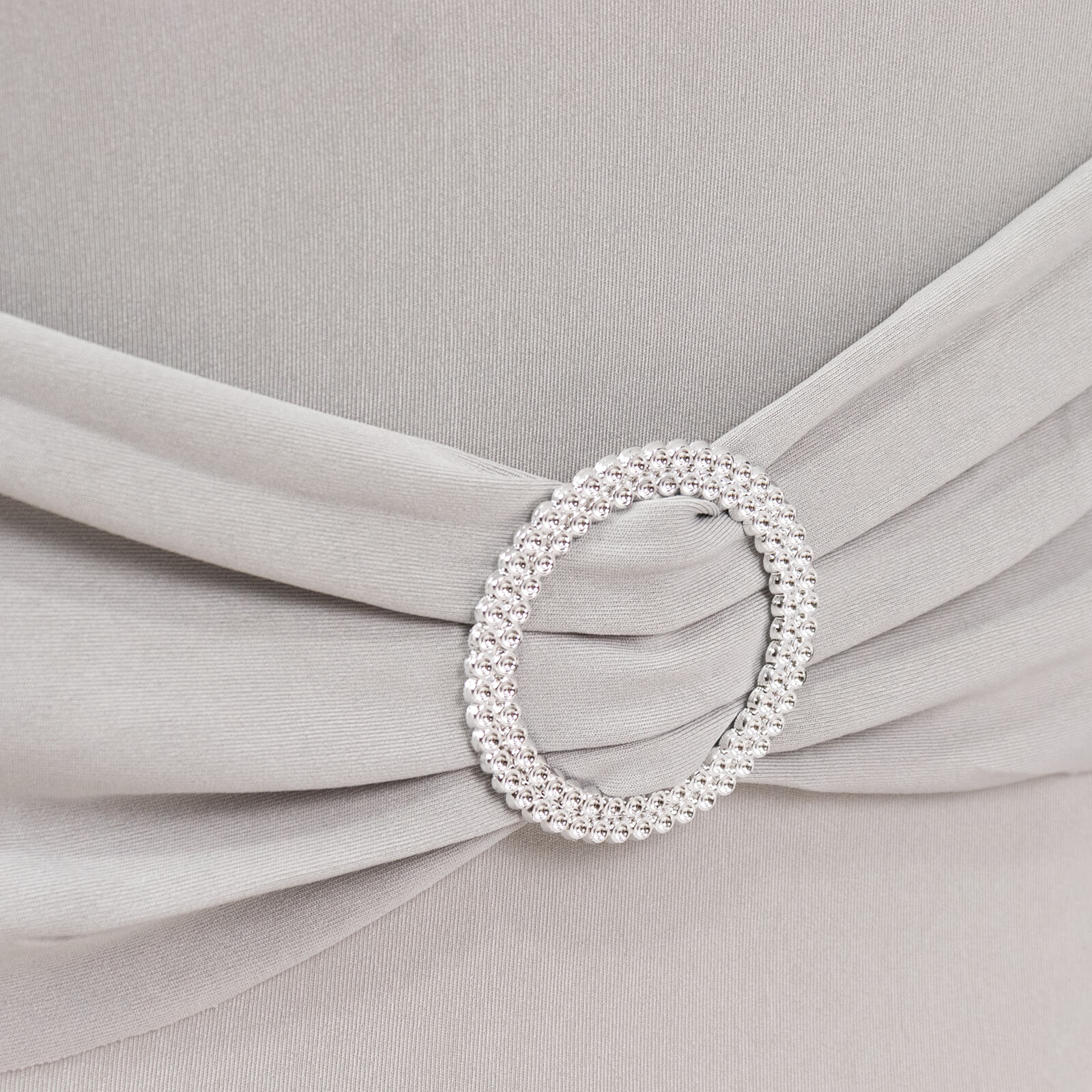 Silver spandex chair cover with rhinestone buckle detail.