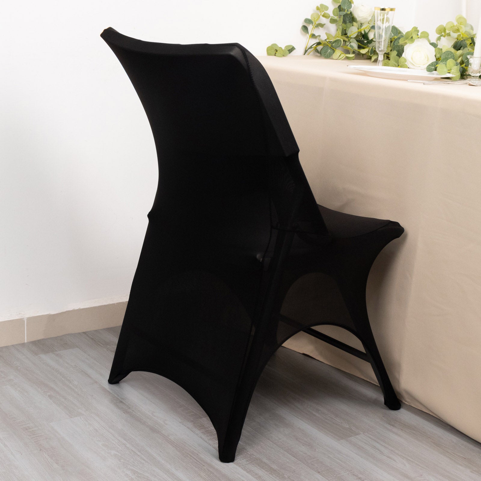 Black spandex wedding chair cover with 3-way open arch and foot pockets.