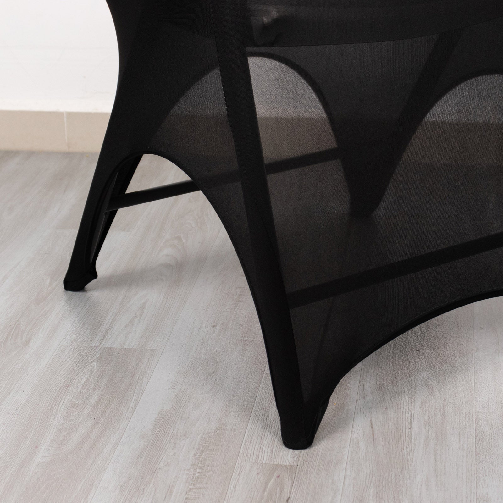Black spandex wedding chair cover with open arch and foot pockets.